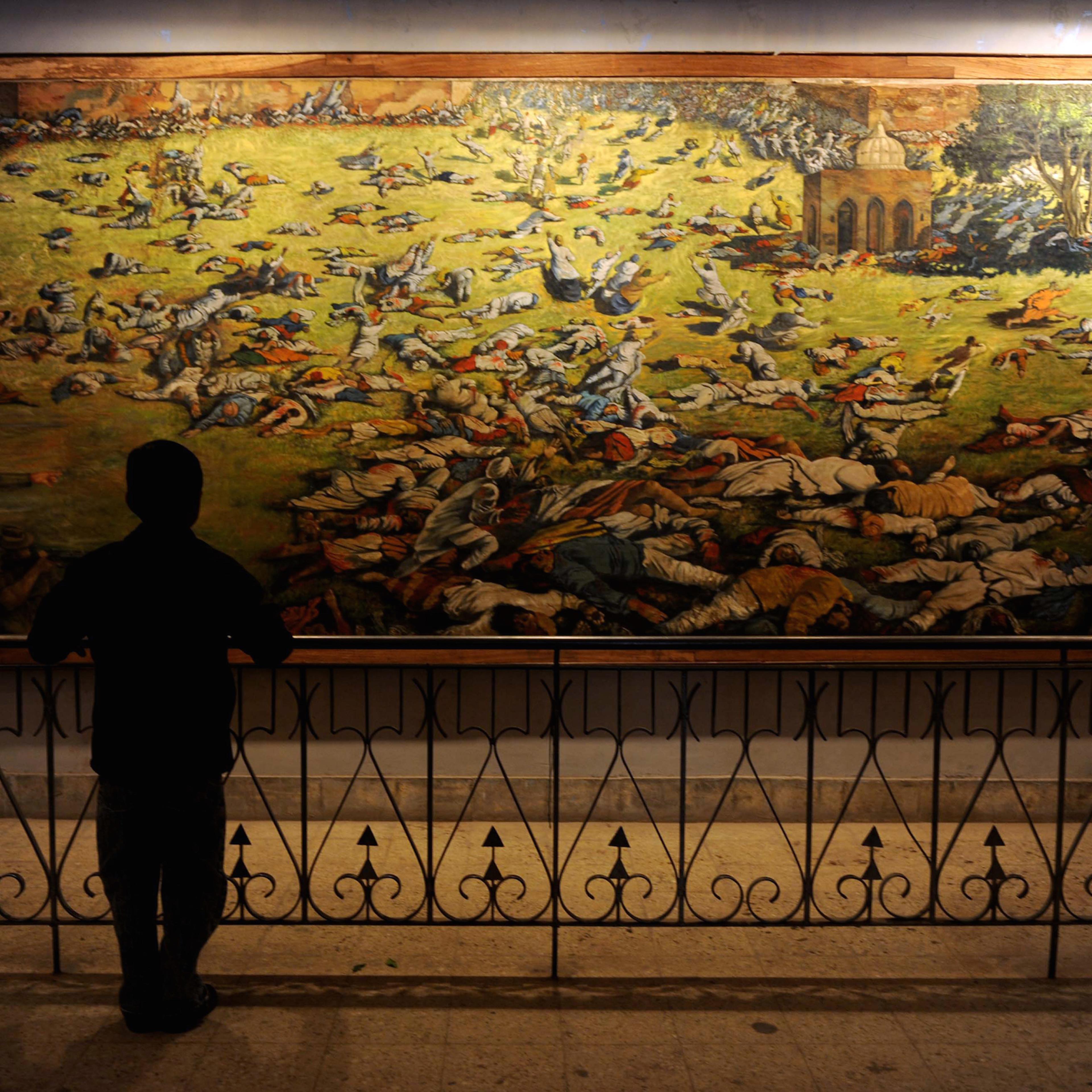 A young visitor looks at a painting depi