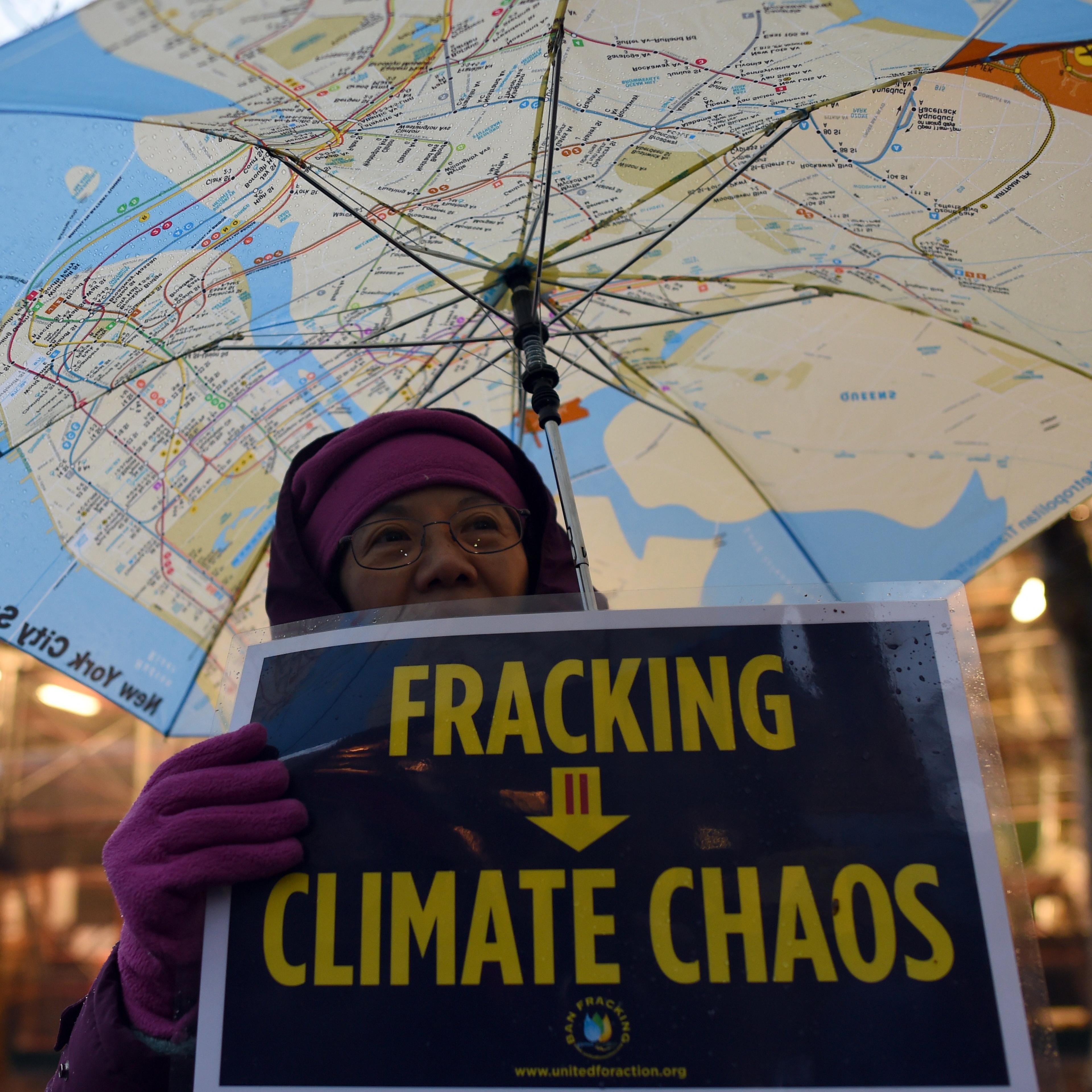 A woman holds an anti-fracking sign as a group of demonstrators gather for a rally for a Global Climate Treaty on Dec. 10, 2014 in New York City.