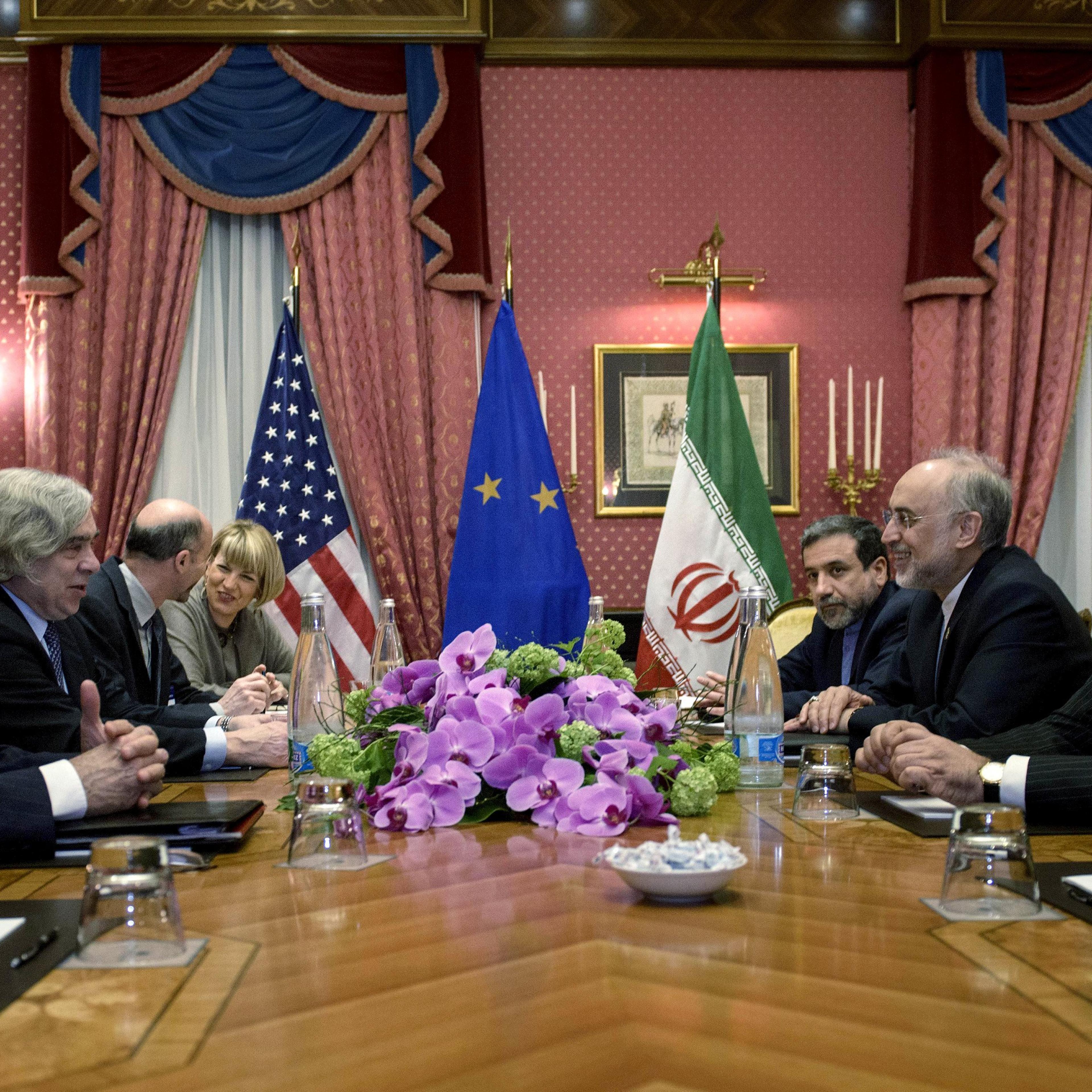 Secretary of State John Kerry, Iranian Foreign Minister Javad Zarif and others wait for a meeting at the Beau Rivage Palace Hotel on March 27, 2015 in Lausanne, Switzerland.