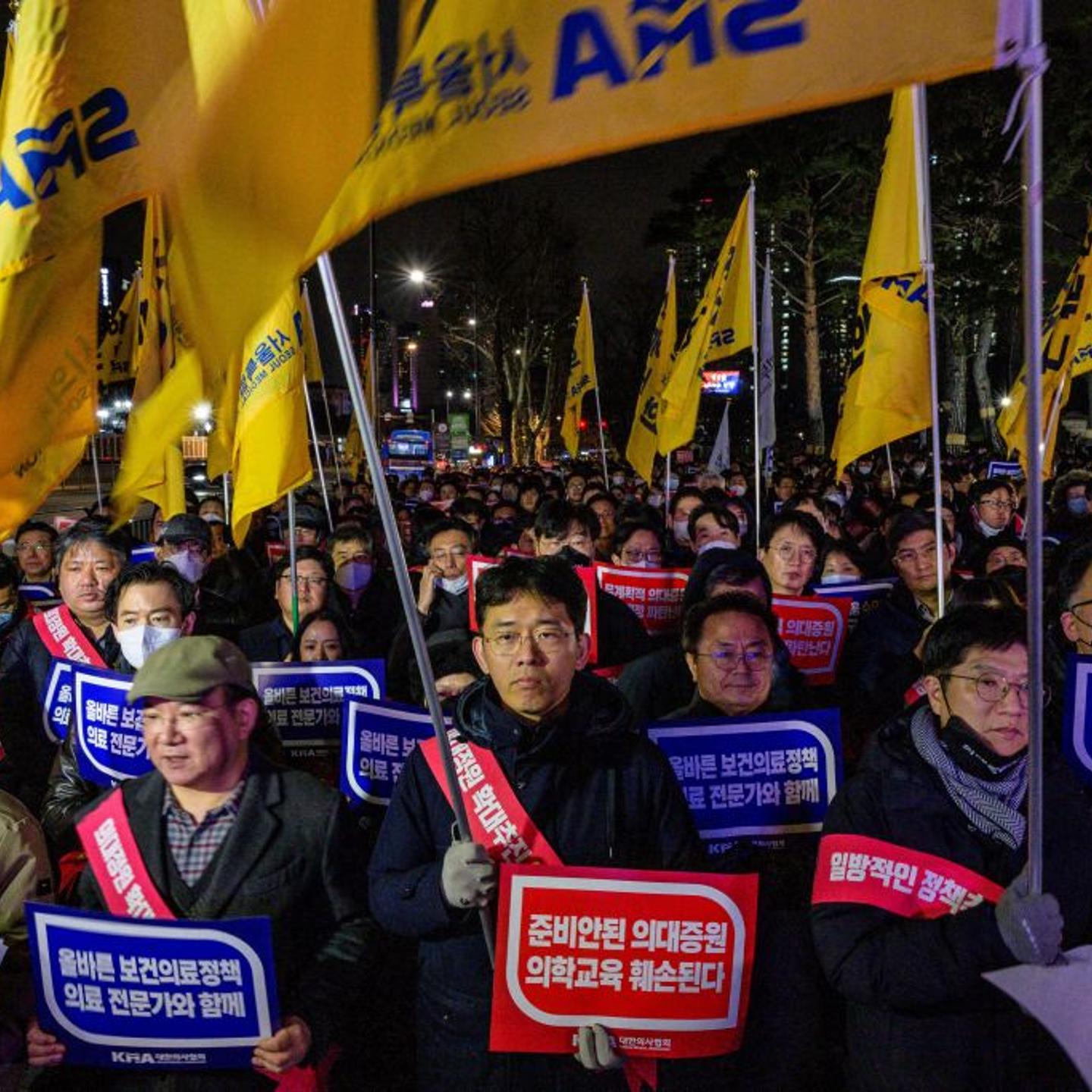 Doctors hold placards that read "Opposition to the increase in medical schools" as they gather to protest against the government's plan to raise the annual enrolment quota at medical schools by 2000 in Seoul on Feb. 15, 2024.