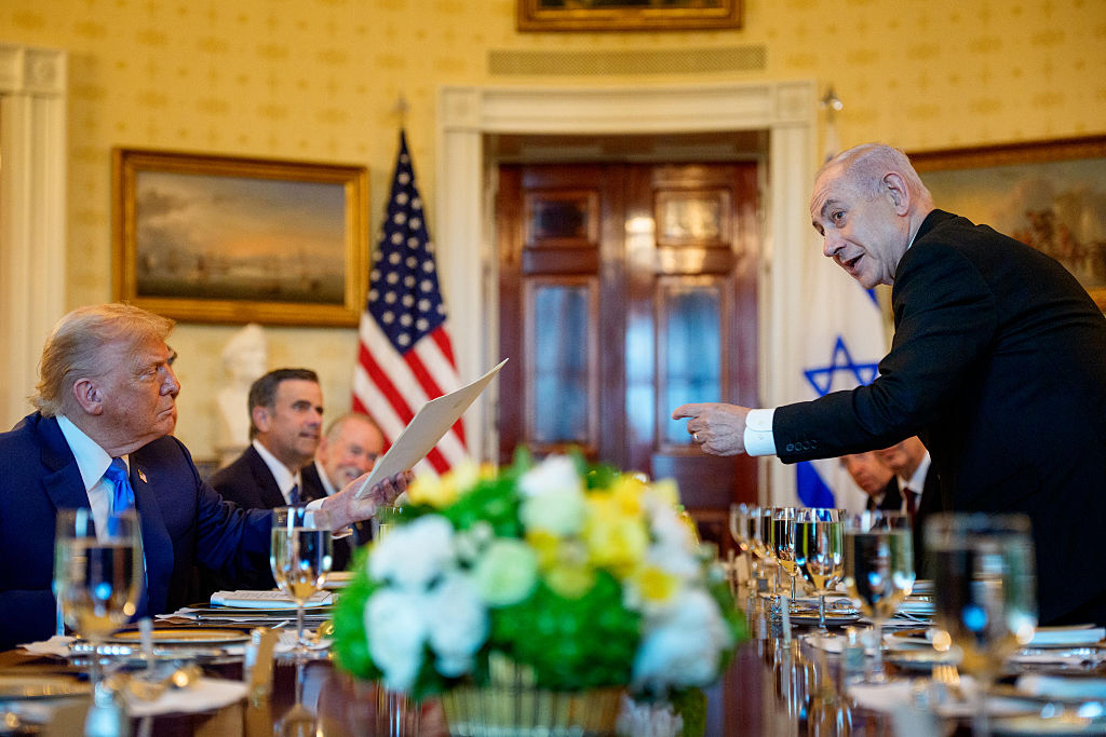 Israeli Prime Minister Benjamin Netanyahu (R) hands off a letter Netanyahu sent to the Nobel Peace Prize committee to nominate U.S. President Donald Trump (L) for the Nobel Peace Prize during a dinner in the Blue Room of the White House in Washington, D.
