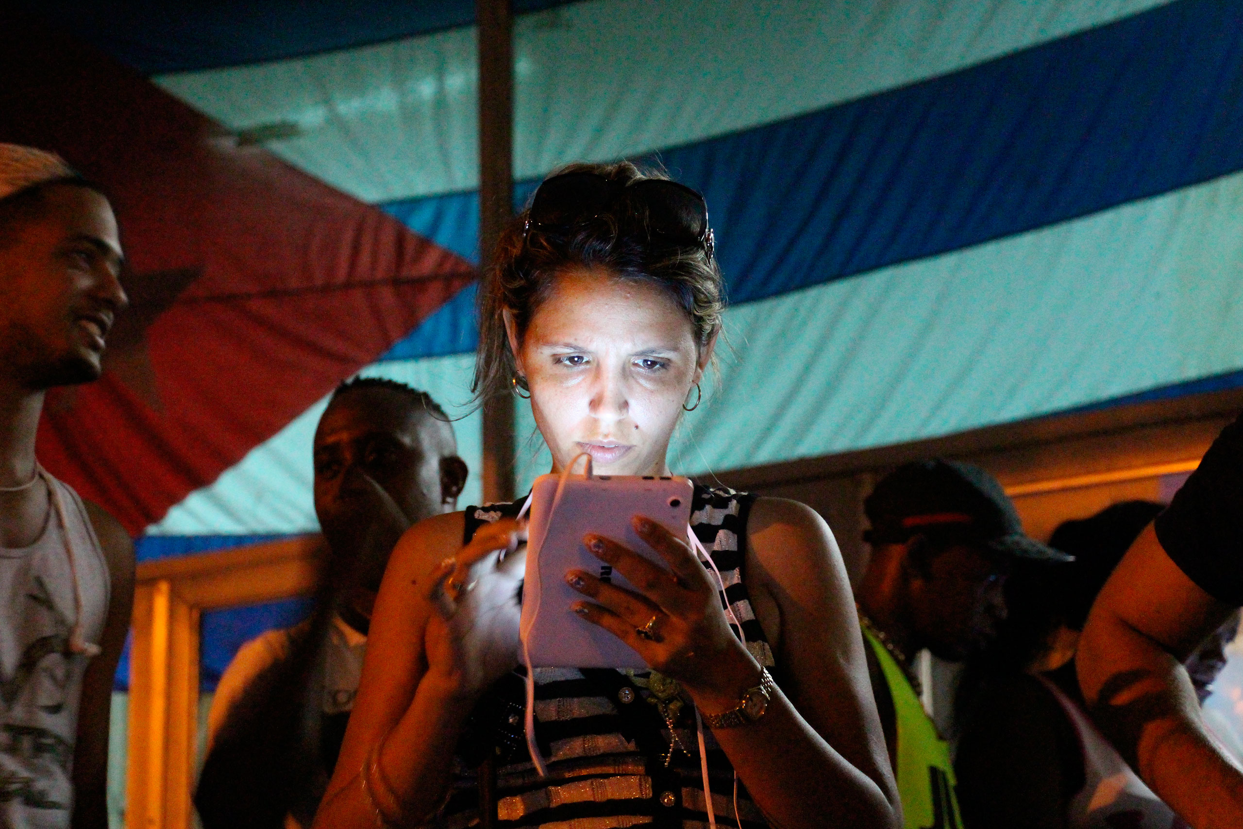 A woman surfs the Internet at a public WiFi spot in the district of Marianao in Havana, Cuba, Oct. 16, 2015.