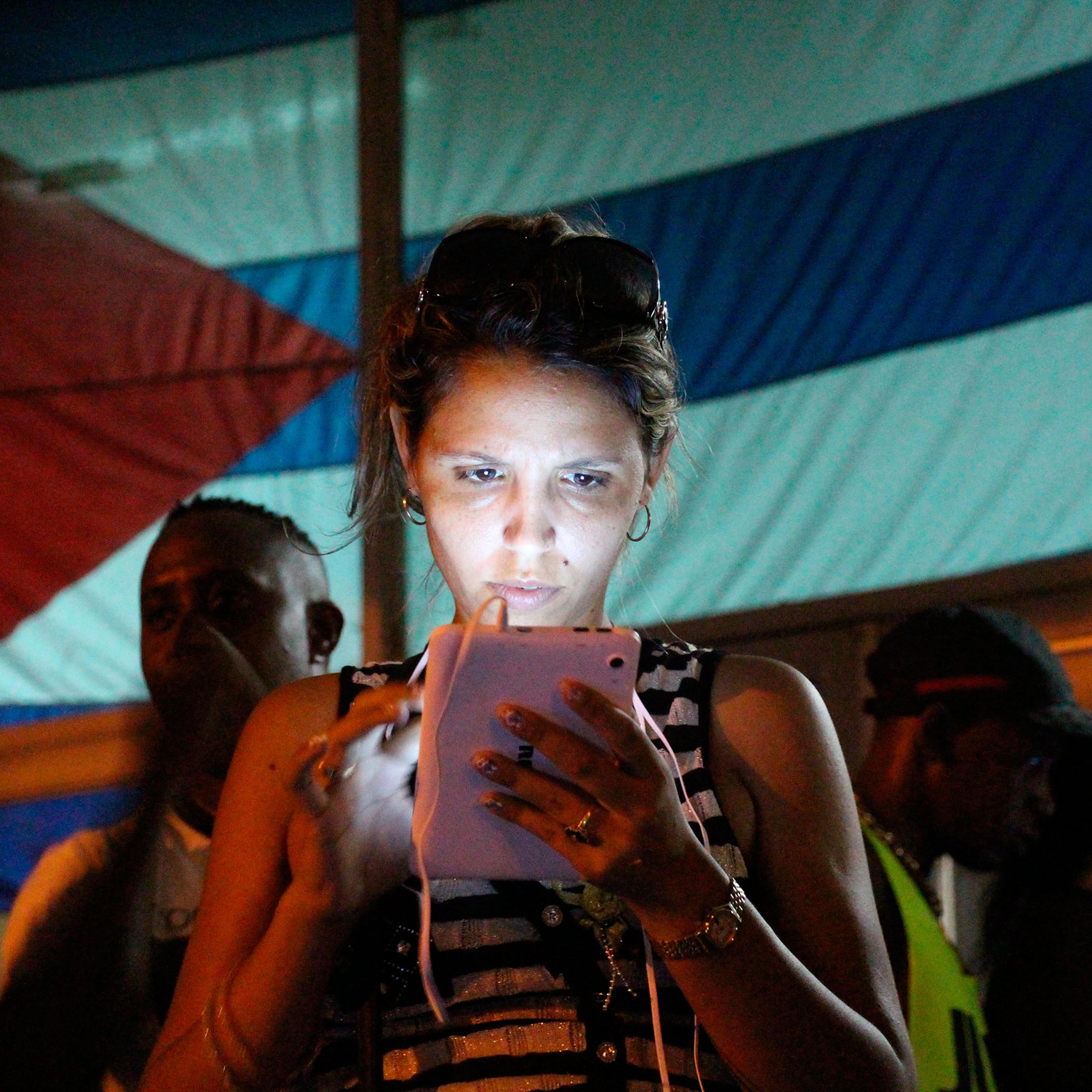 A woman surfs the Internet at a public WiFi spot in the district of Marianao in Havana, Cuba, Oct. 16, 2015.