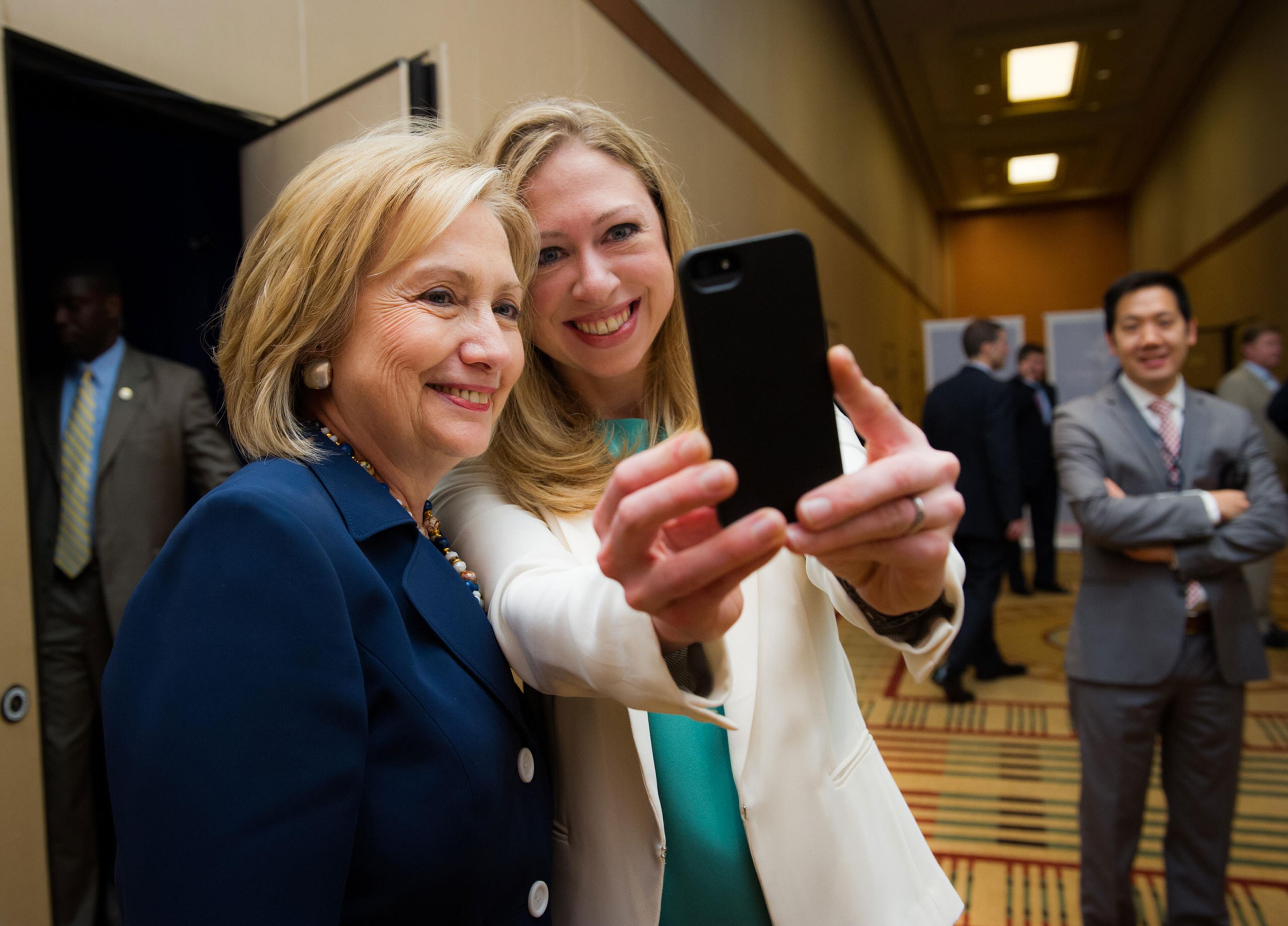 At a Clinton Global Initiative meeting. Secretary of State Hillary Clinton and Chelsea take a selfie.