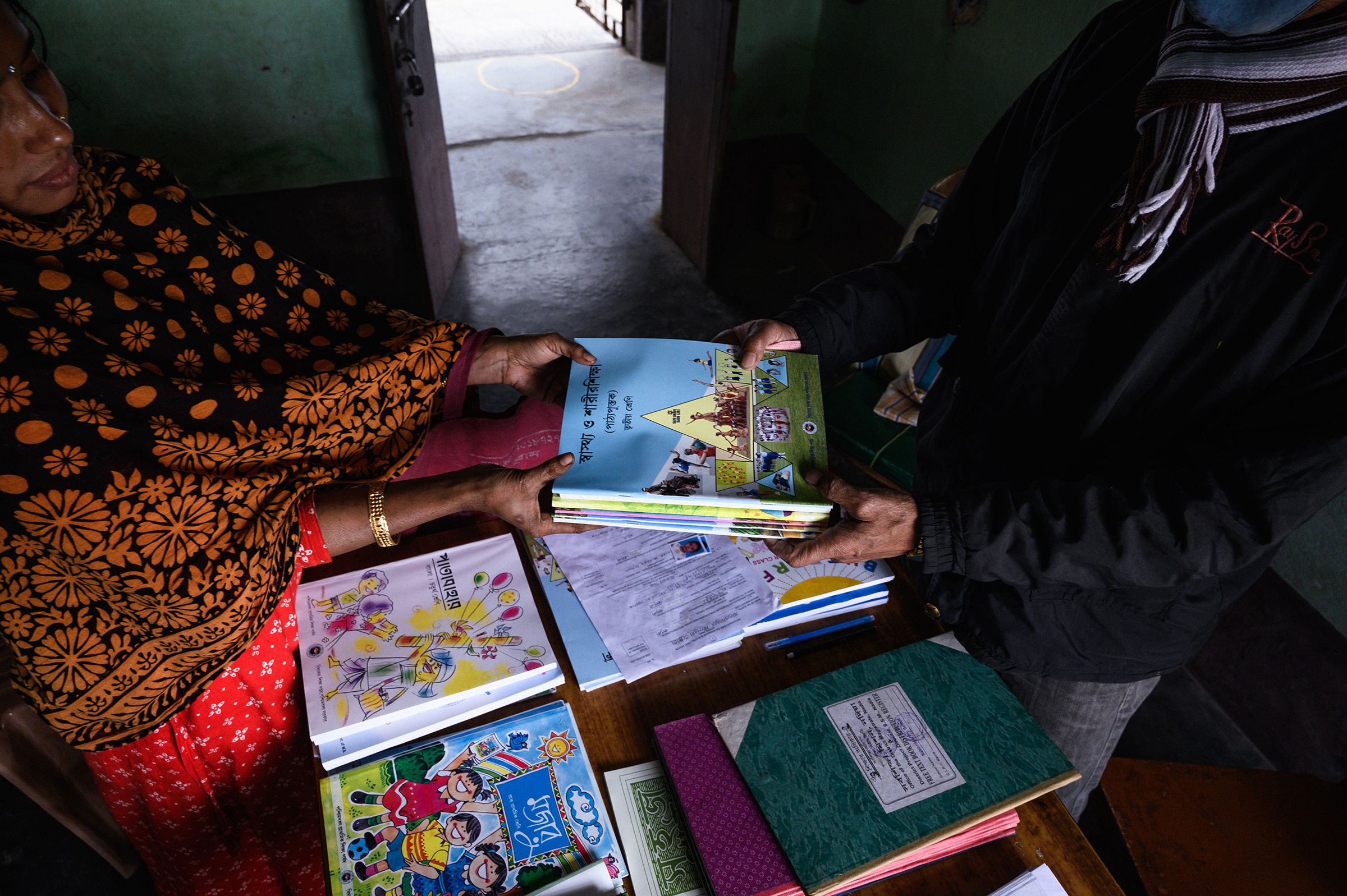 New school books are distributed to students at a rural primary school at Nabin Nagar, India, on Jan. 5, 2022.