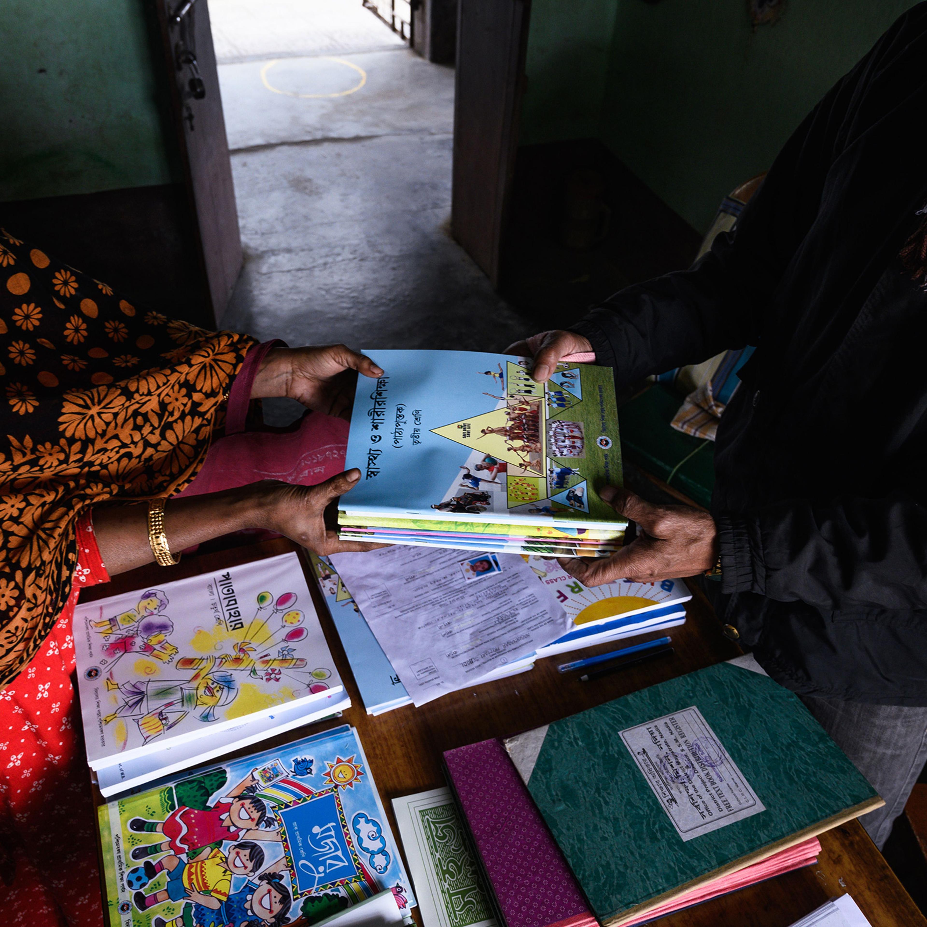 New school books are distributed to students at a rural primary school at Nabin Nagar, India, on Jan. 5, 2022.