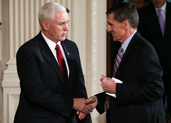Vice President Mike Pence (L) shakes hands with National Security Adviser Michael Flynn before U.S. President Donald Trump and Japanese Prime Minister Shinzo Abe hold a joint press conference at the White House on February 10, 2017 in Washington, DC.