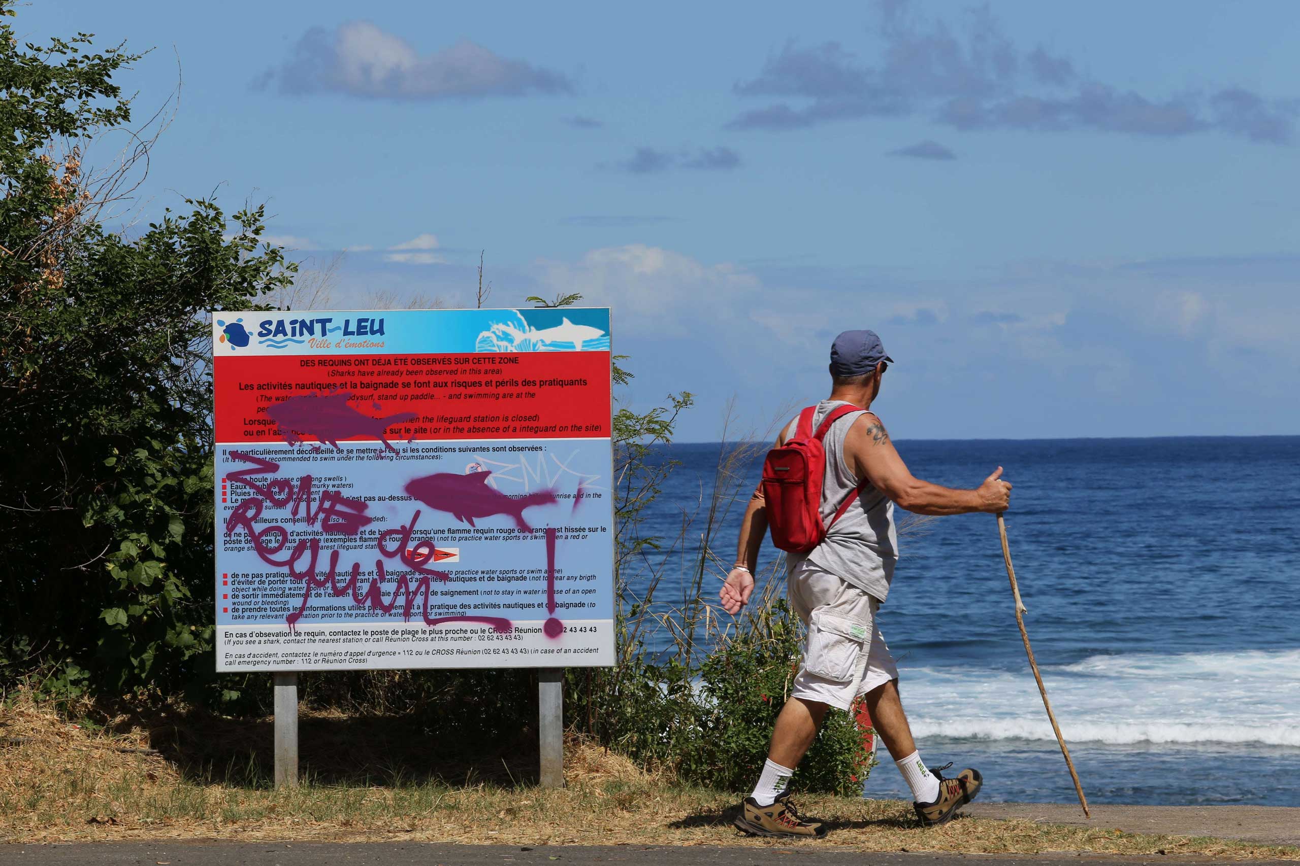A graffiti reading "Shark's area" has been written on an information board, on April 14, 2015 off Saint-Leu, on the western coast of the French Indian Ocean island of La Reunion, two days after a 13-year-old Elio Canestri was attacked and killed by a sha
