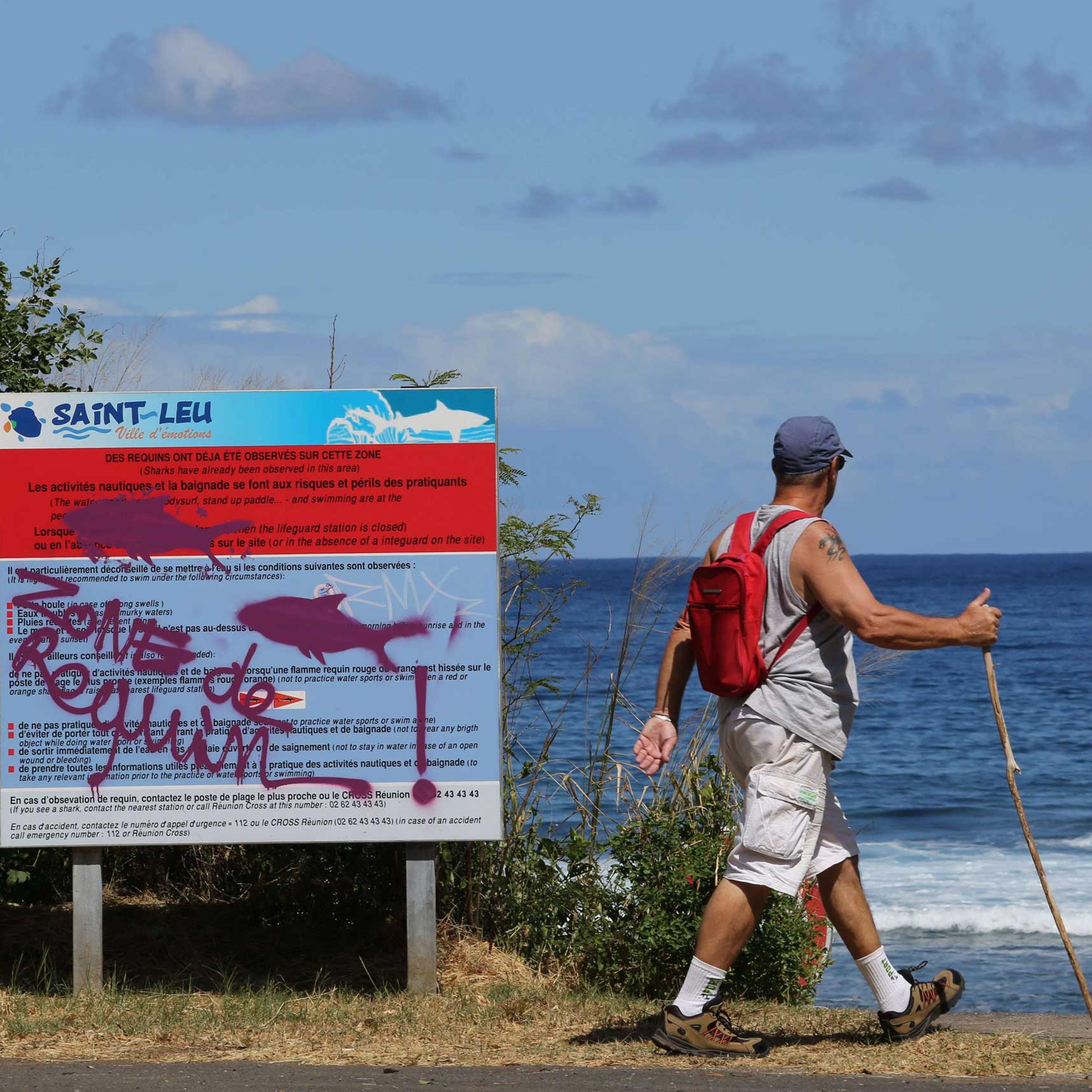 A graffiti reading "Shark's area" has been written on an information board, on April 14, 2015 off Saint-Leu, on the western coast of the French Indian Ocean island of La Reunion, two days after a 13-year-old Elio Canestri was attacked and killed by a sha