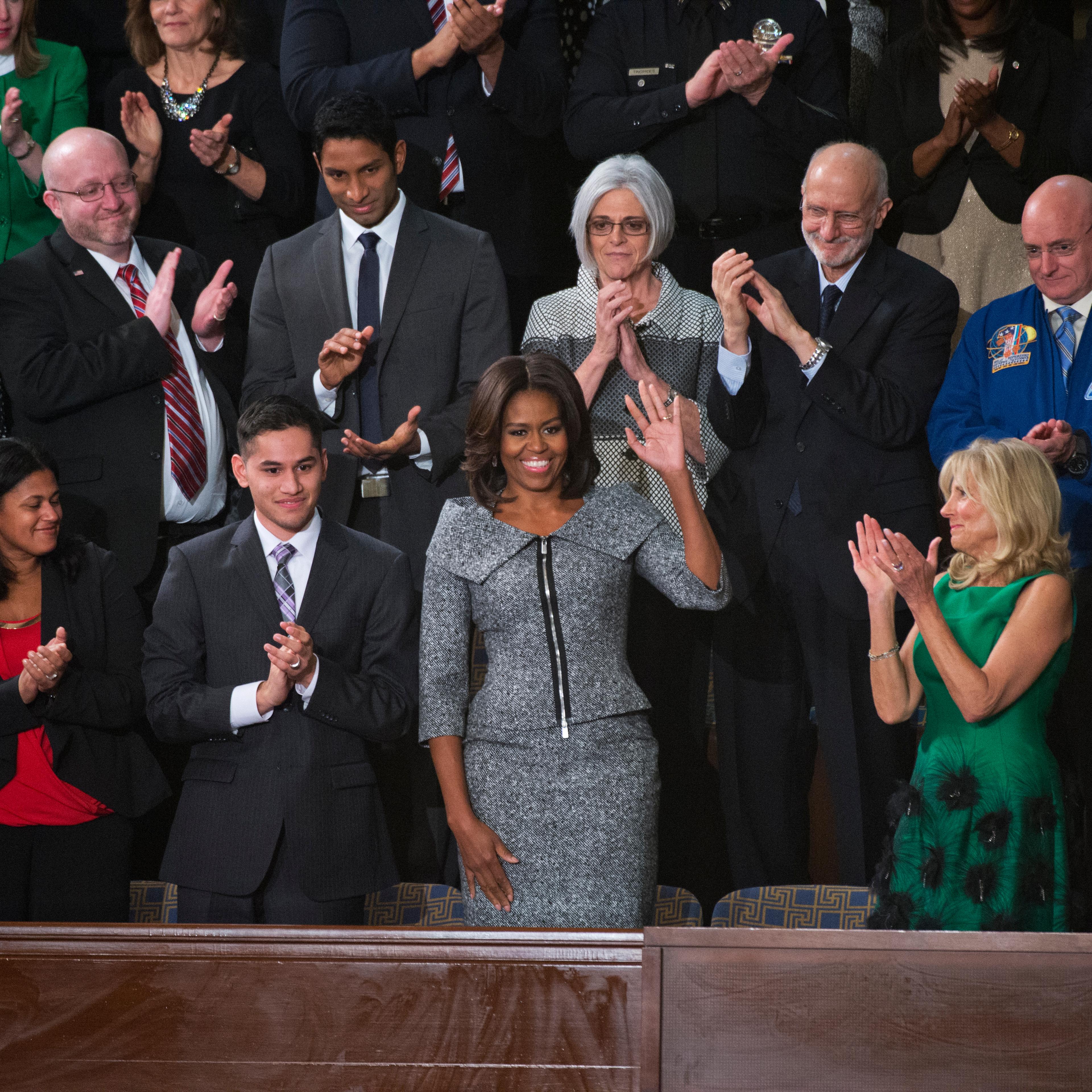 UNITED STATES - JANUARY 20: First Lady Michelle Obama arrives in the Capitol's House chamber before President Barack Obama's State of the Union address, January 20, 2015. Jill Biden, wife of Vice President Joe Biden, appears at right. (Photo By Tom Willi