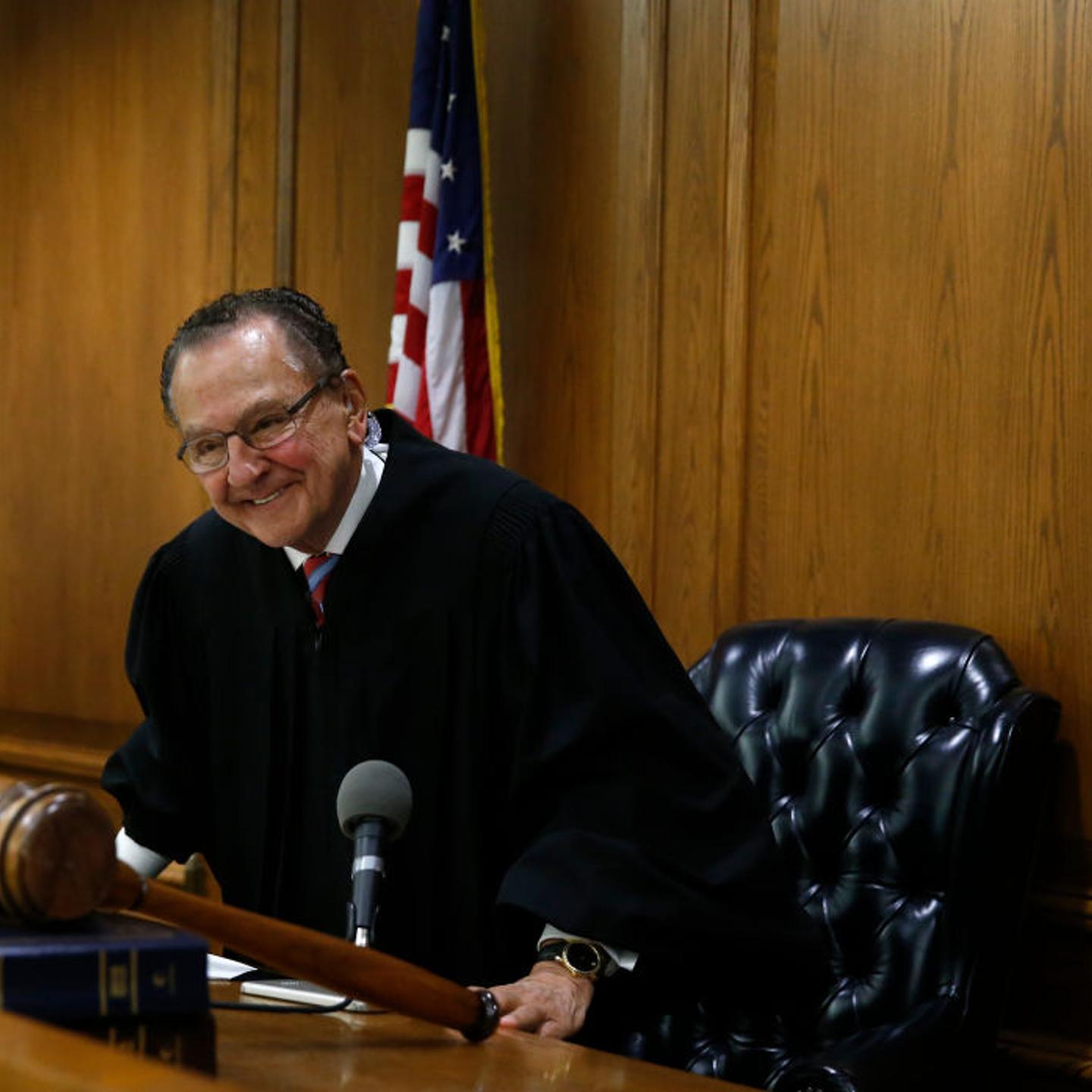 Judge Frank Caprio smiles behind bench