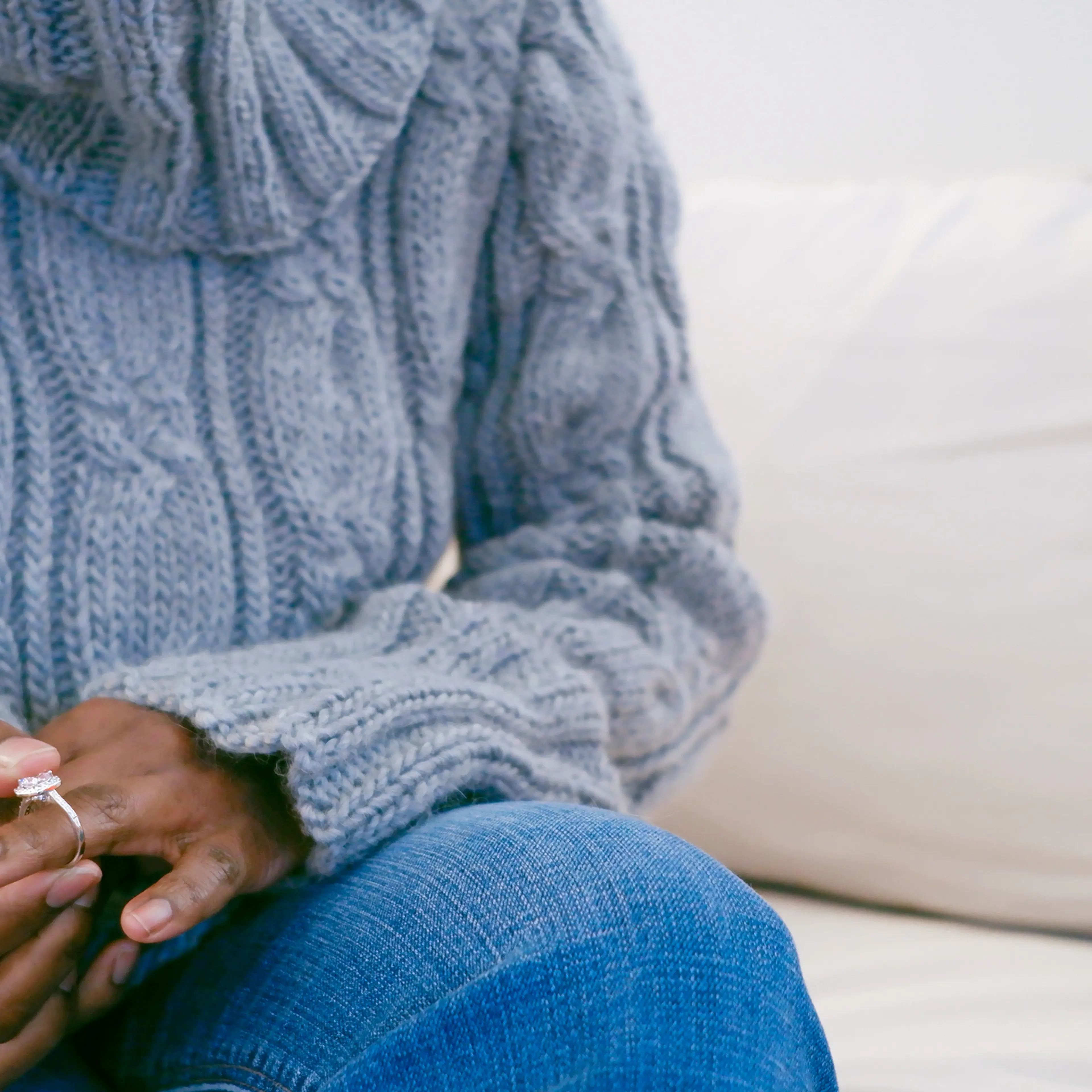 A woman removes a ring from her finger.