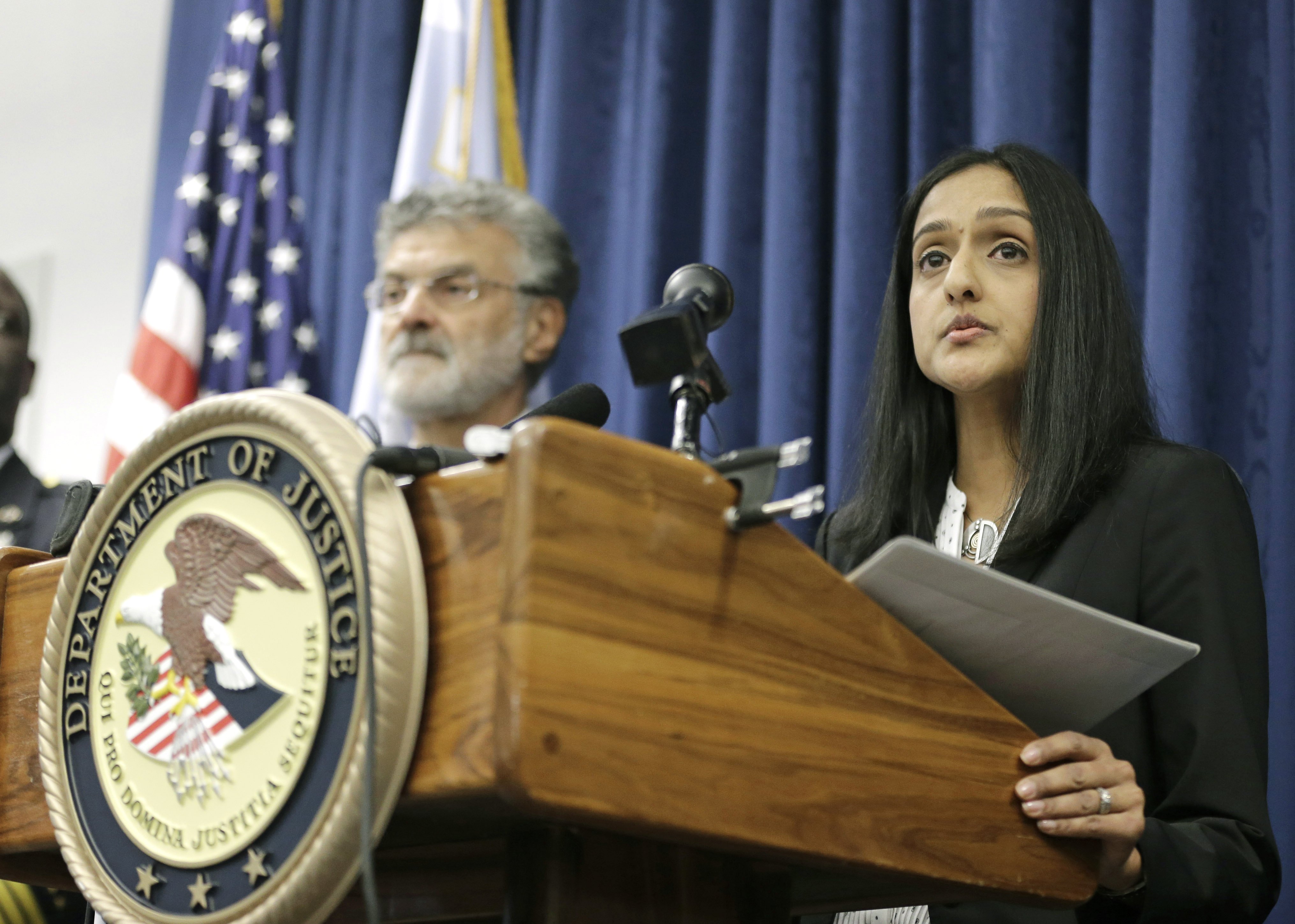 U.S. Acting Assistant Attorney General Vanita Gupta for the Civil Rights Division, right, makes a statement during a news conference on Dec. 4, 2014, in Cleveland.