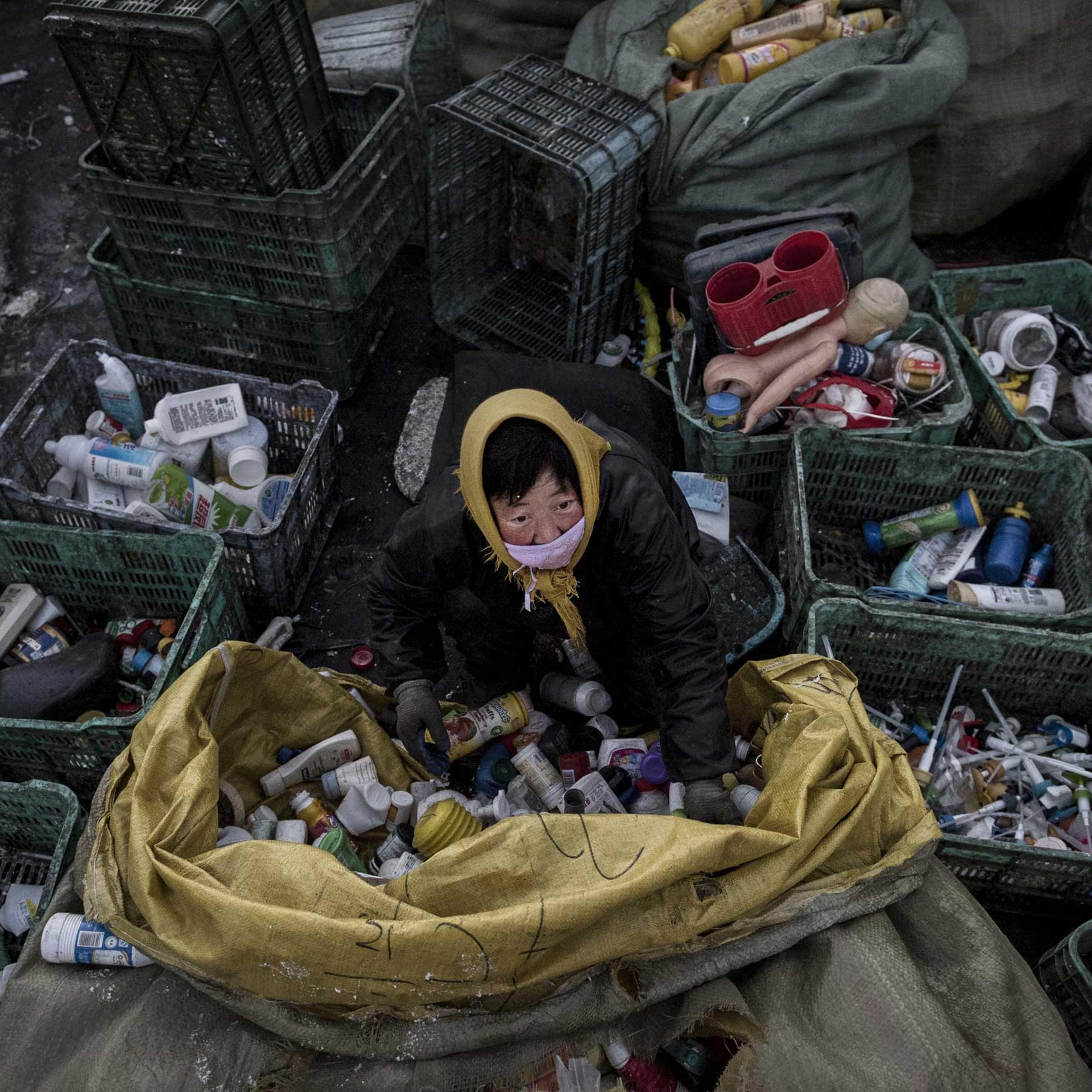 A Chinese laborer sorts plastic before being recycled in the Dong Xiao Kou village on Dec. 15, 2014 in Beijing.
