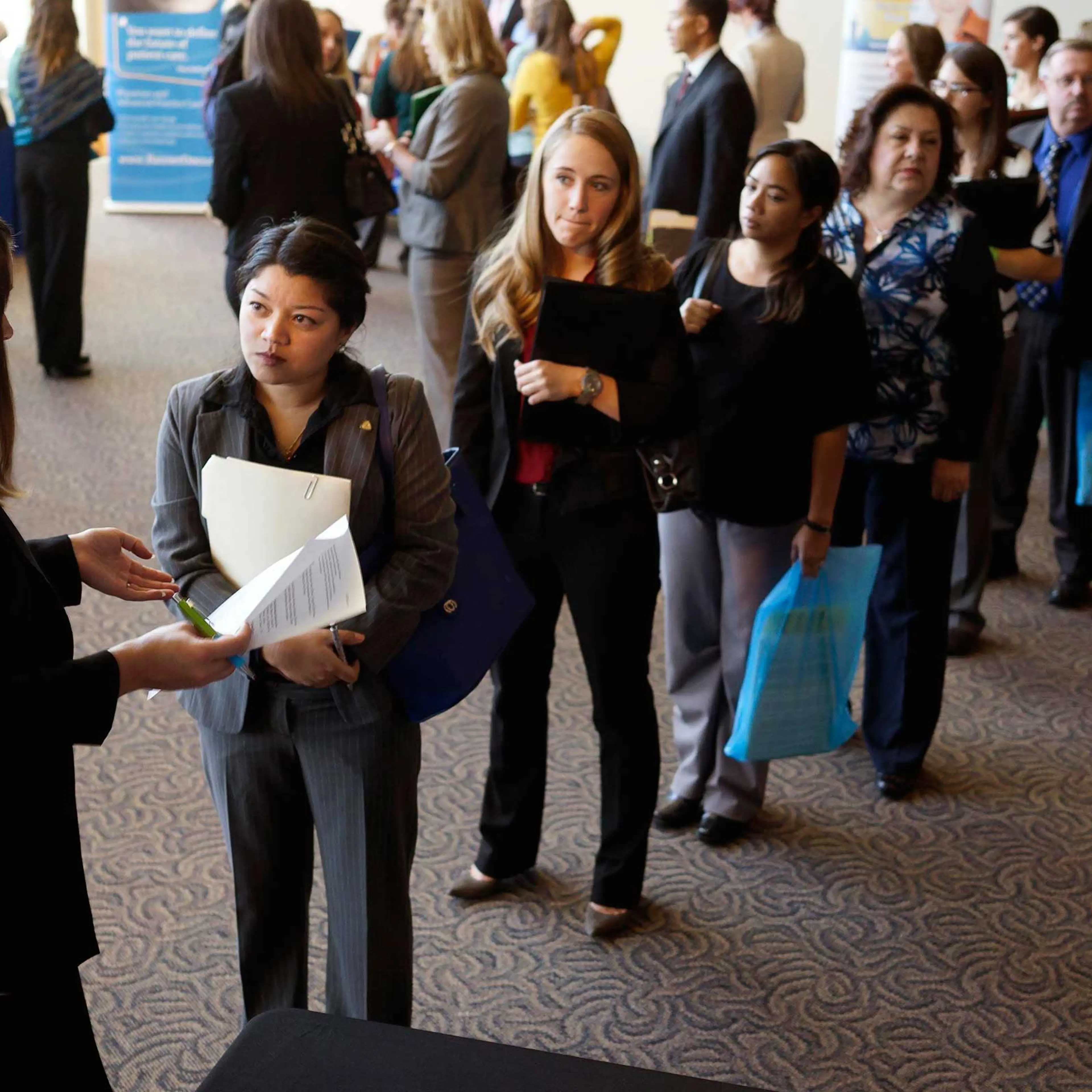 Jobseekers wait to talk to a recruiter at the Colorado Hospital Association's health care career event in Denver, Oct. 13, 2014.