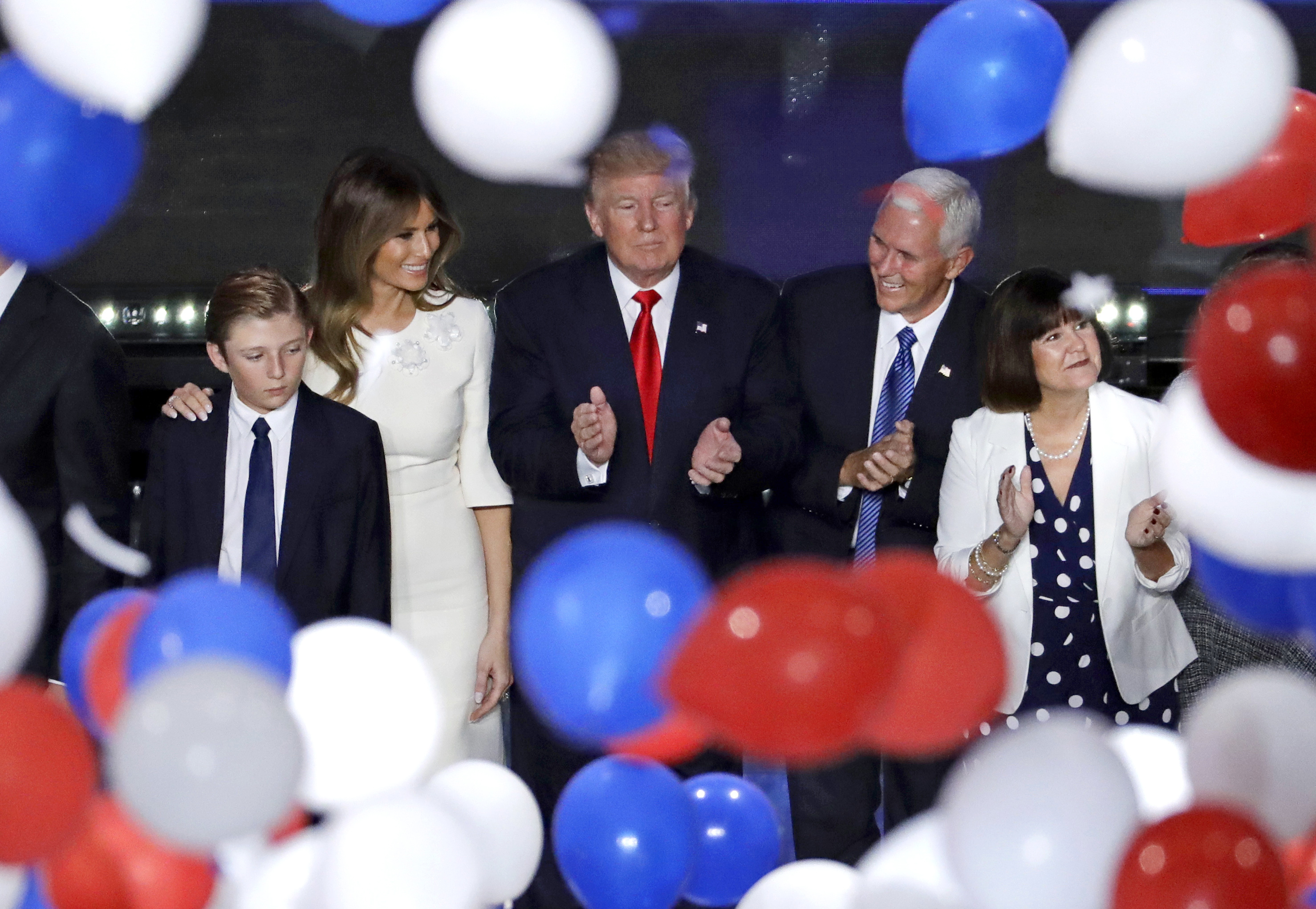Republican presidential candidate Donald Trump, center, along with, from left, son Barron, wife Melania, Gov. Mike Pence of Indiana and Pence's wife Karen after Trump's address to delegates during the final day session of the Republican National Conventi
