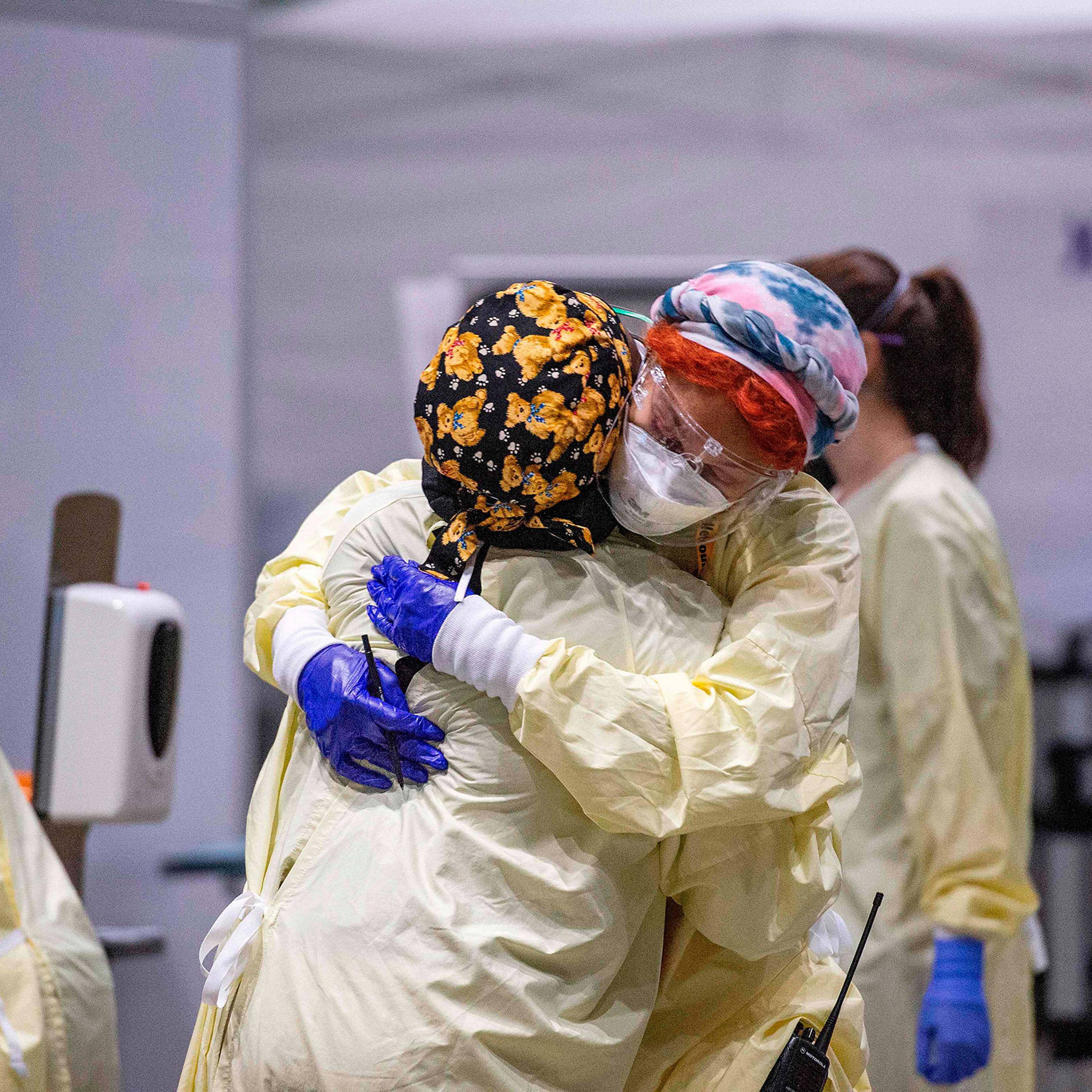 Medical worker Margaret Watkins embraces co-worker Shelly Burke as part of their morning therapy inside the hot zone where medical staff monitor and treat sick patients infected with Covid-19 at the UMASS Memorial DCU Center Field Hospital in Worcester,