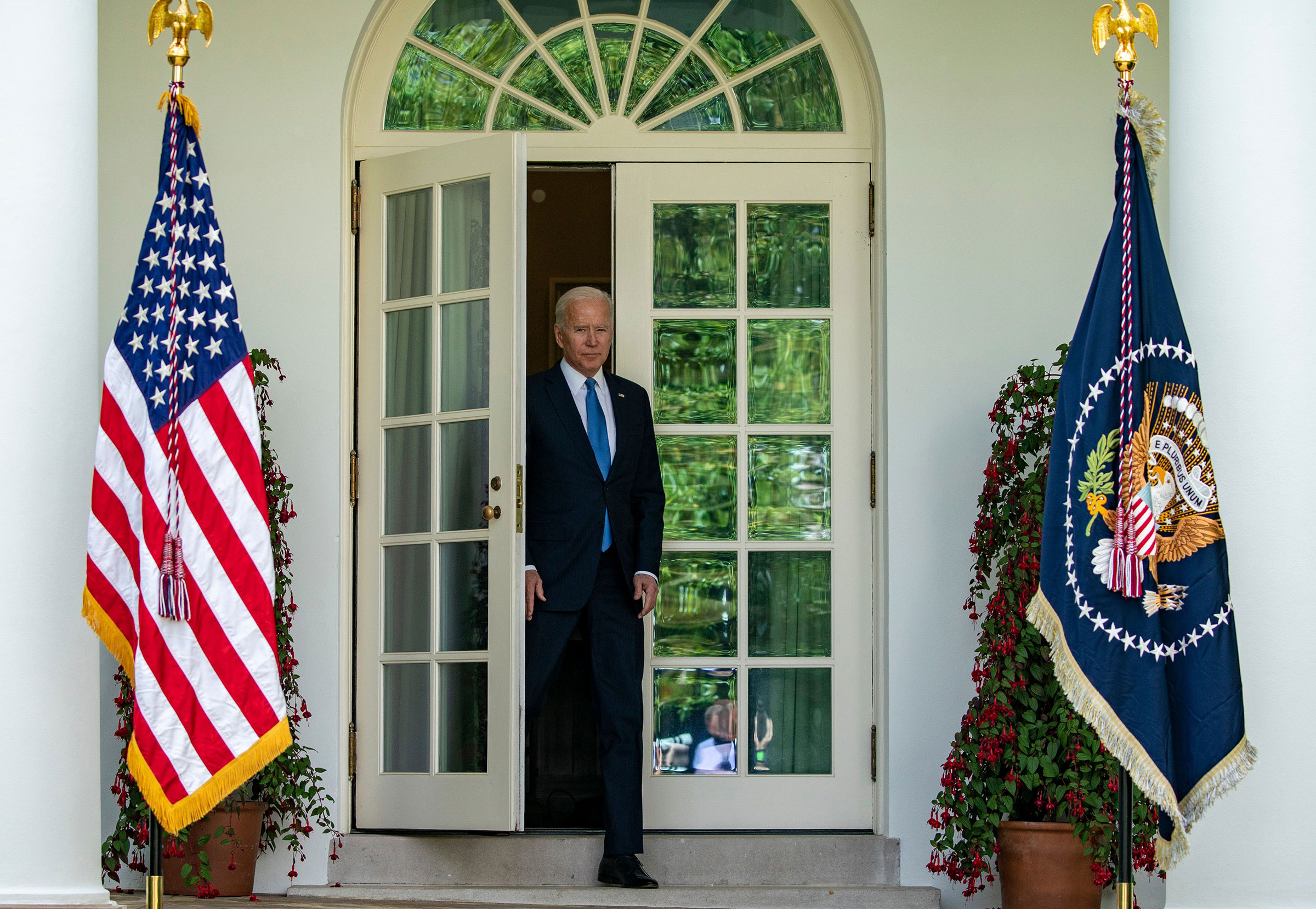 President Joe Biden enters the rose garden to give remarks May 13, 2021.