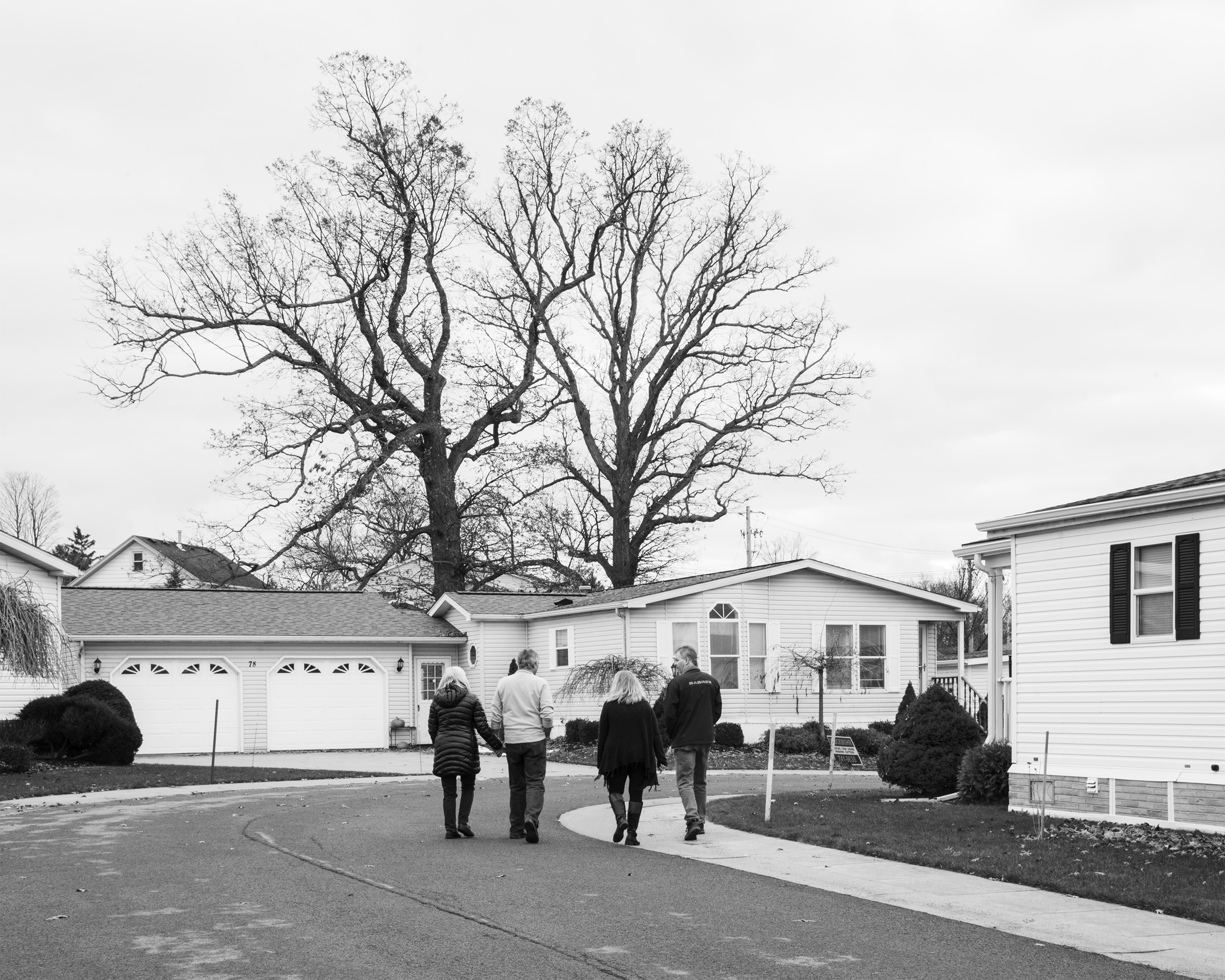 Residents walk in the Akron Mobile Home Park