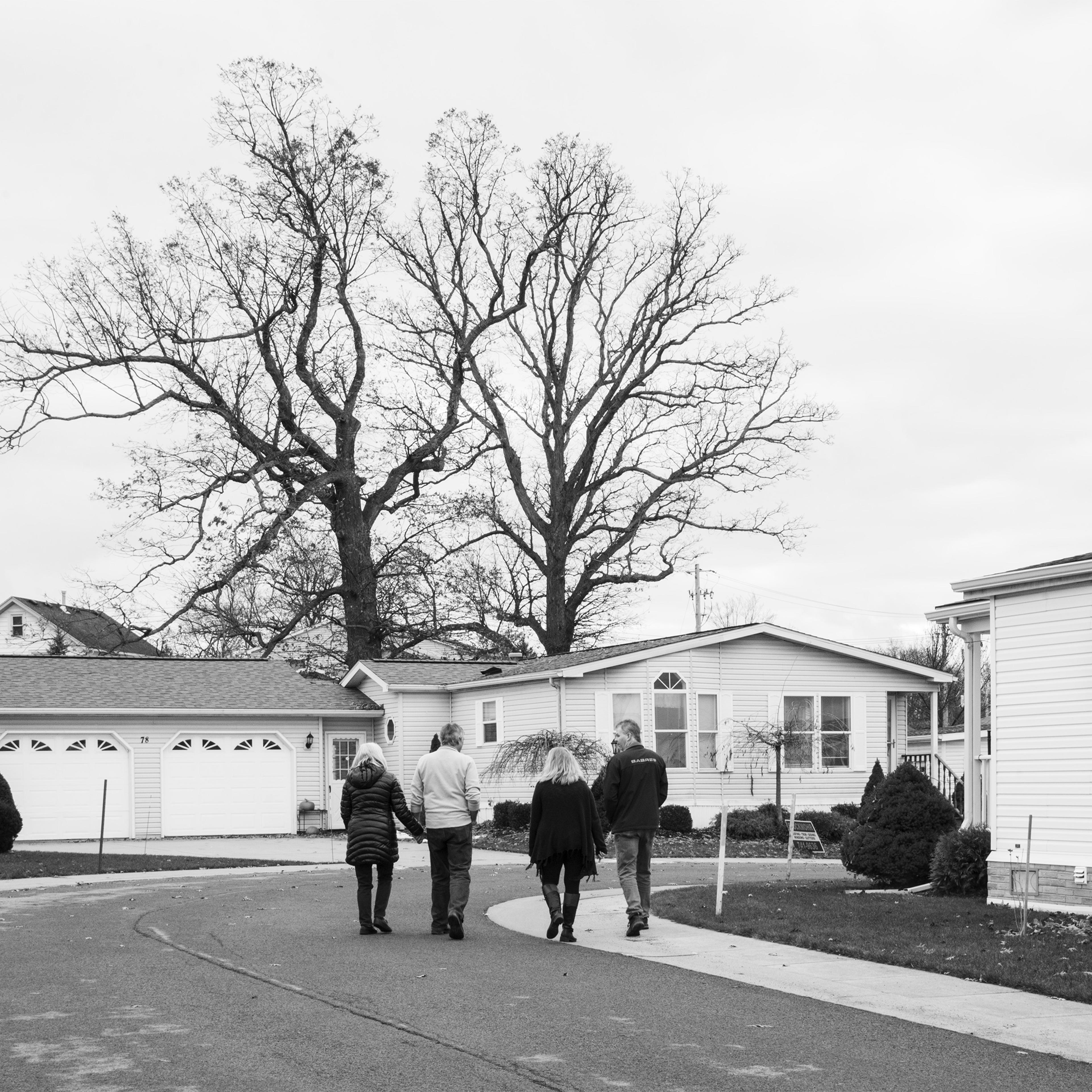 Residents walk in the Akron Mobile Home Park