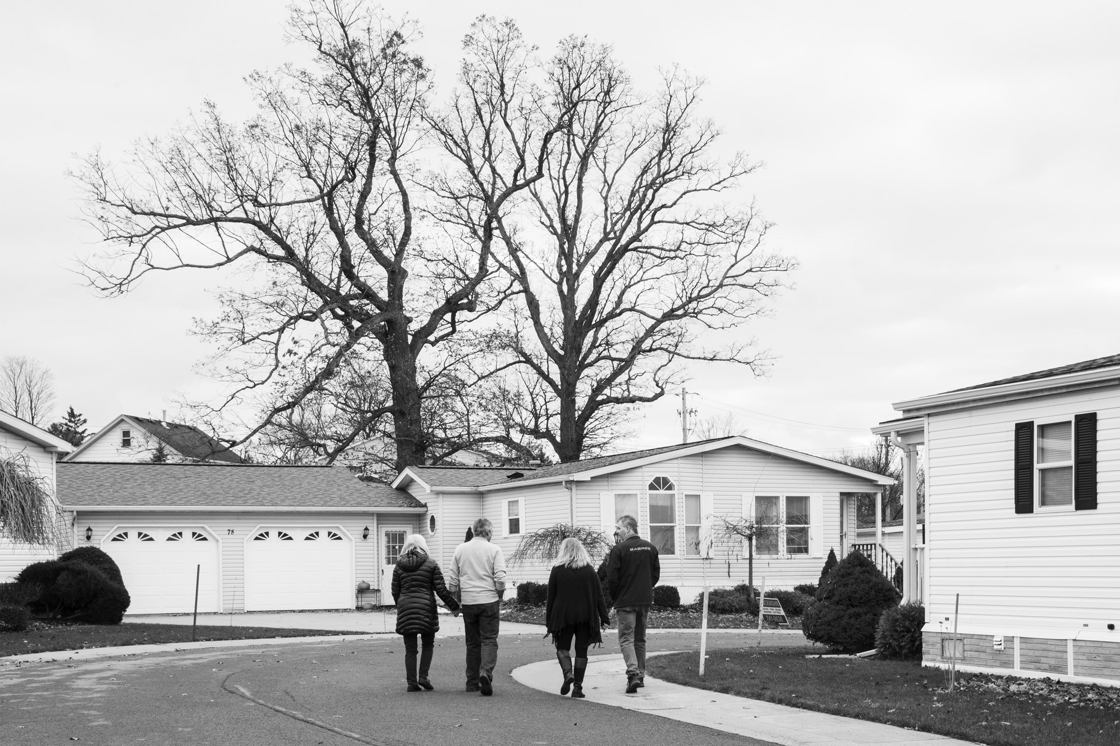 Residents walk in the Akron Mobile Home Park