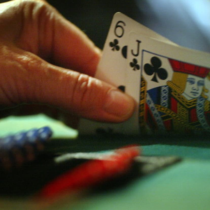 A player peeks at their hand, the popularity of Texas Hold 'Em Poker is increasing, both online and in person. Philthy McNasty's, on Eglinton Avenue East has tournaments every Monday in Toronto, March 7, 2005.