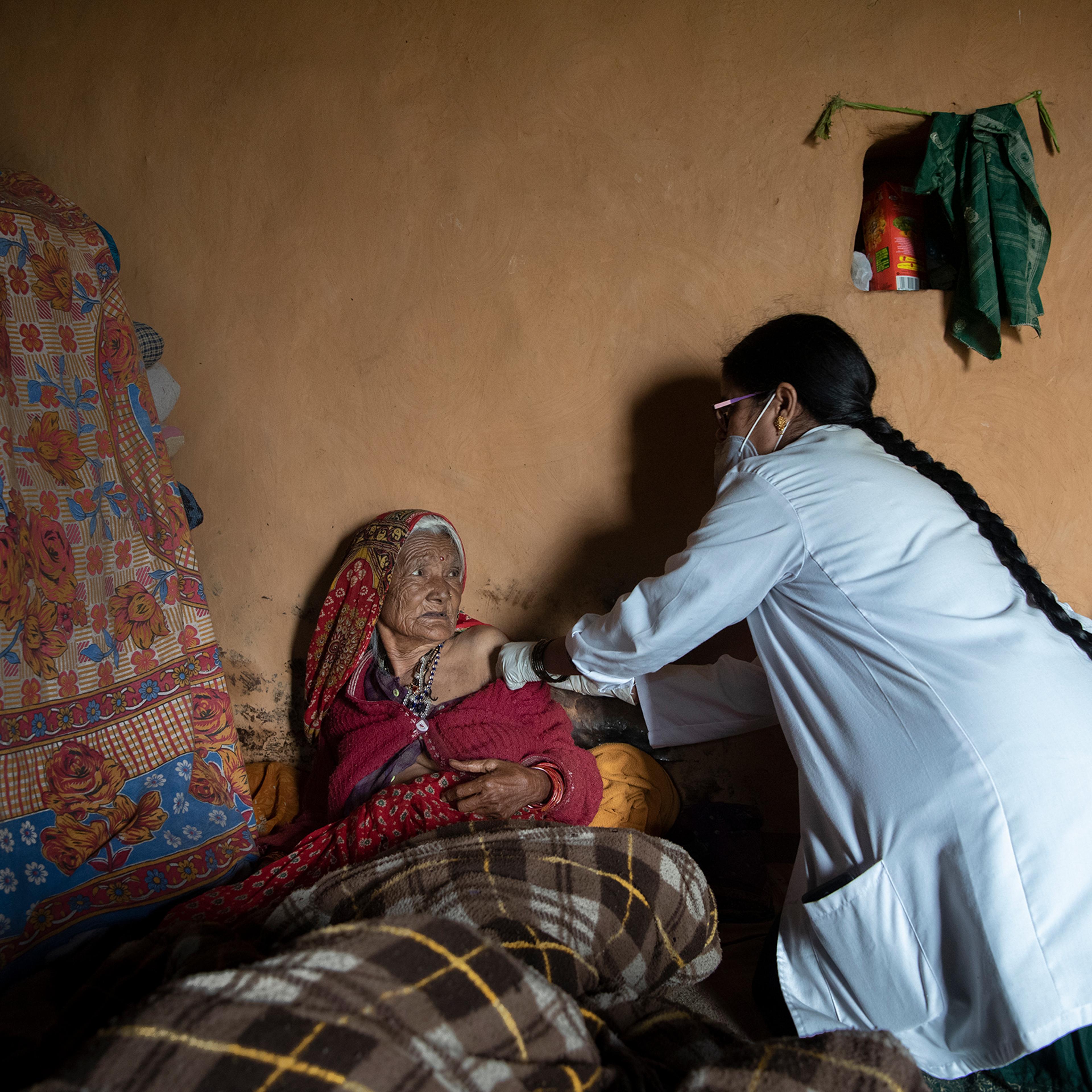 Gokuli Devi, 80, receives a vaccine at her home near Aghariya, India, on Sept. 4 because she is too frail to walk to a local site
