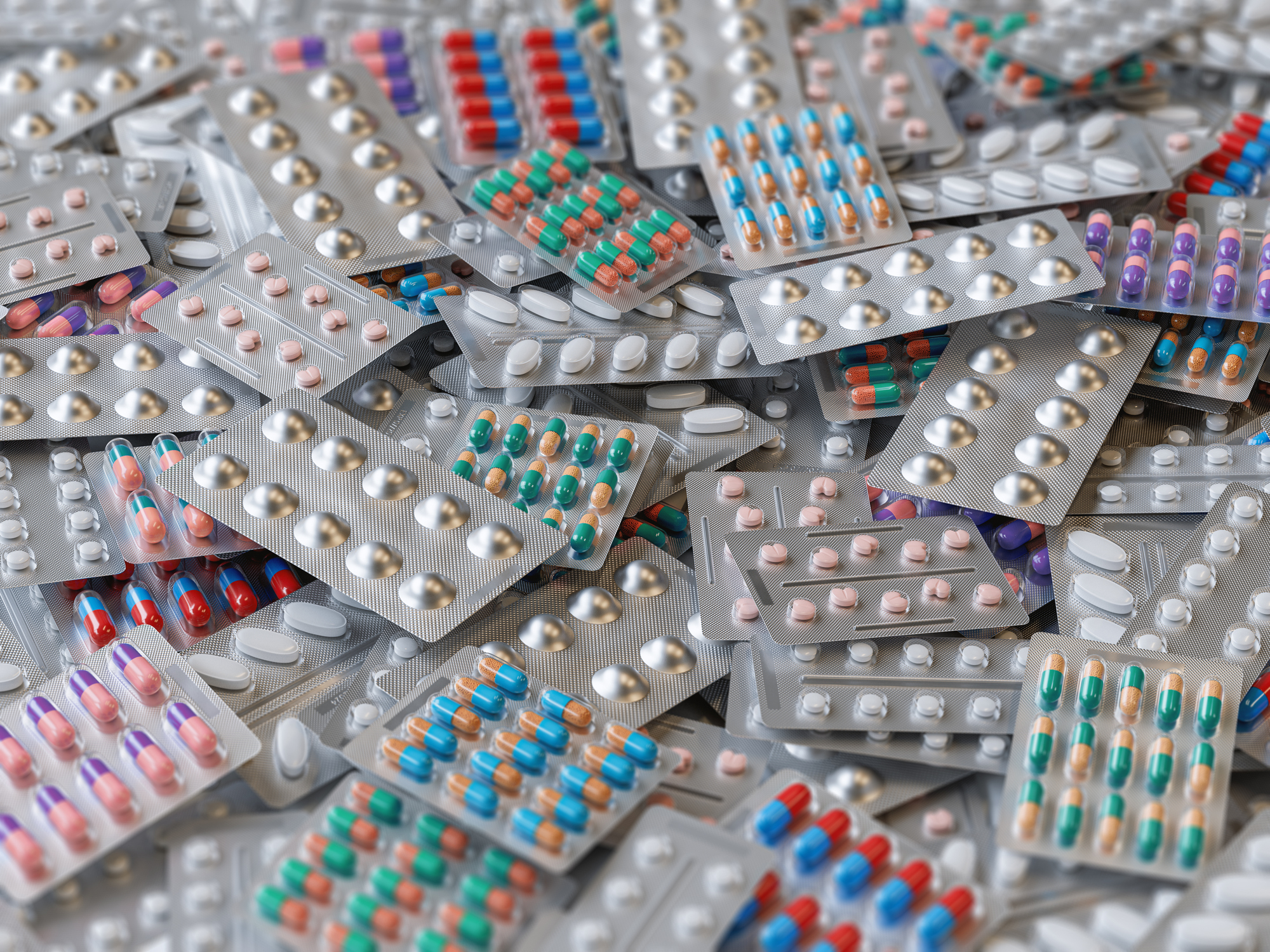 Big heap of various pills and tablets packs and blisters