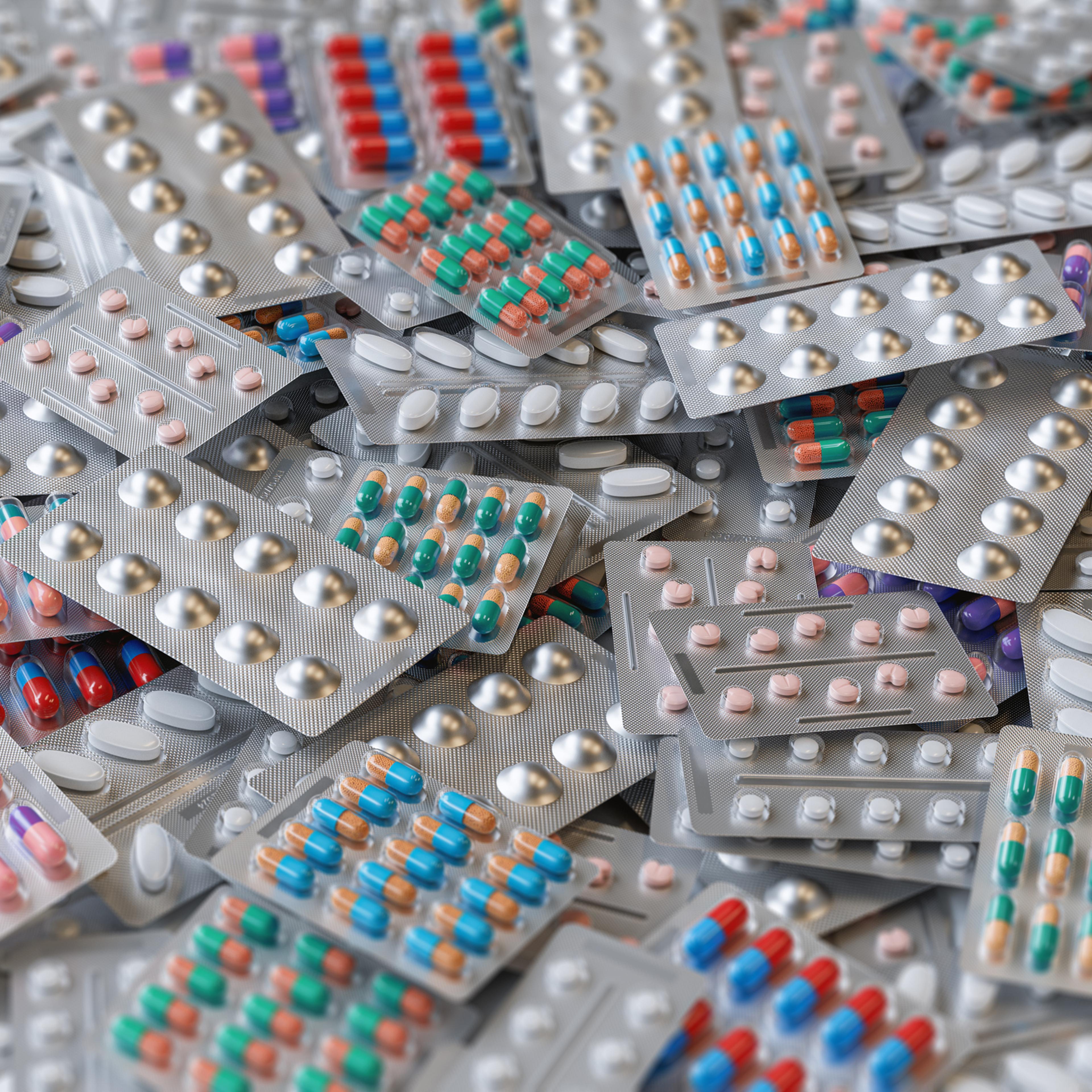 Big heap of various pills and tablets packs and blisters