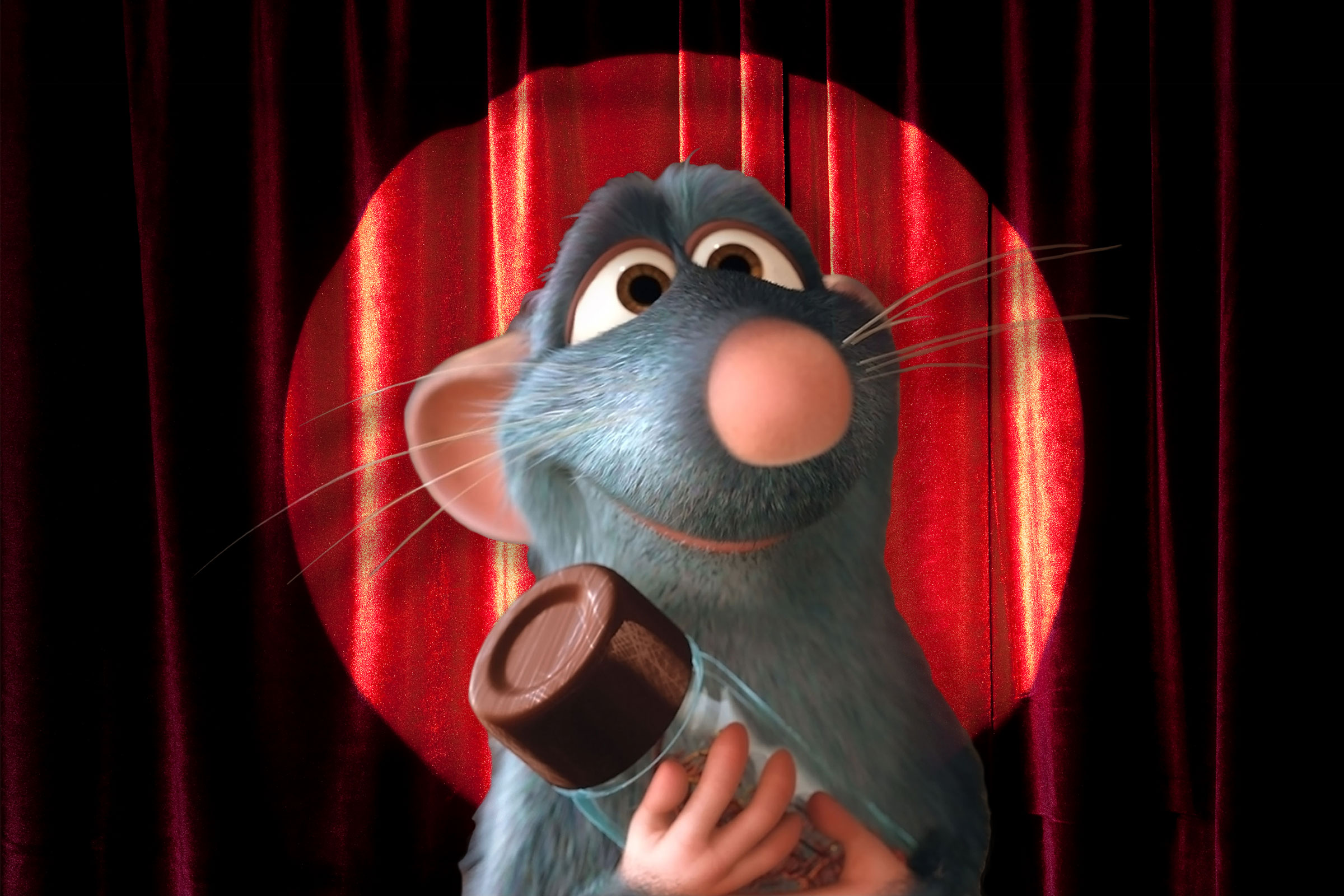 Remy from the movie Ratatouille in front of a stage screen