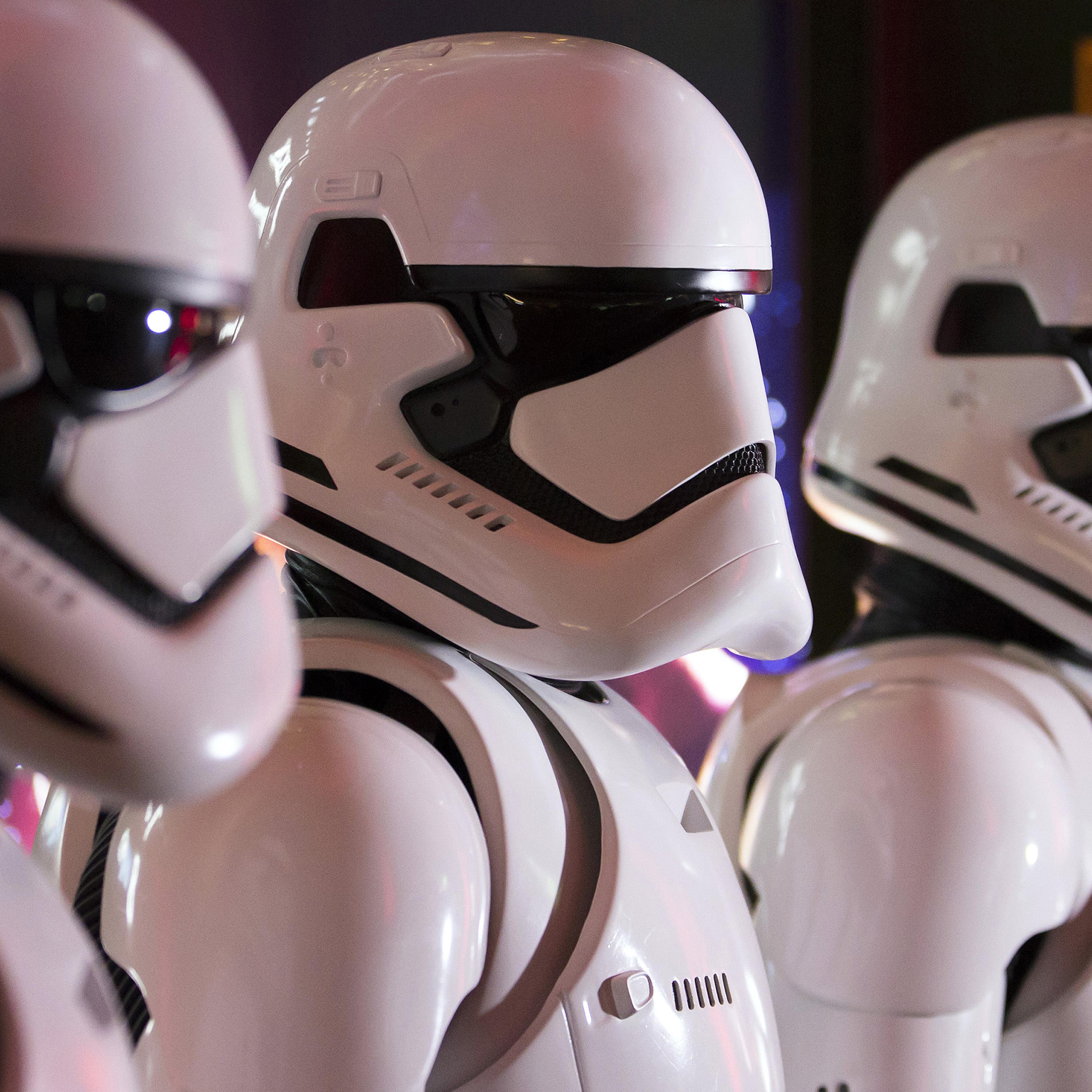 Fans wear Storm Trooper costumes ahead of the first public screening of Walt Disney Co.'s "Star Wars: The Force Awakens" at TOHO Cinemas Roppoing Hills in Tokyo, Japan, on Friday, Dec. 18, 2015.