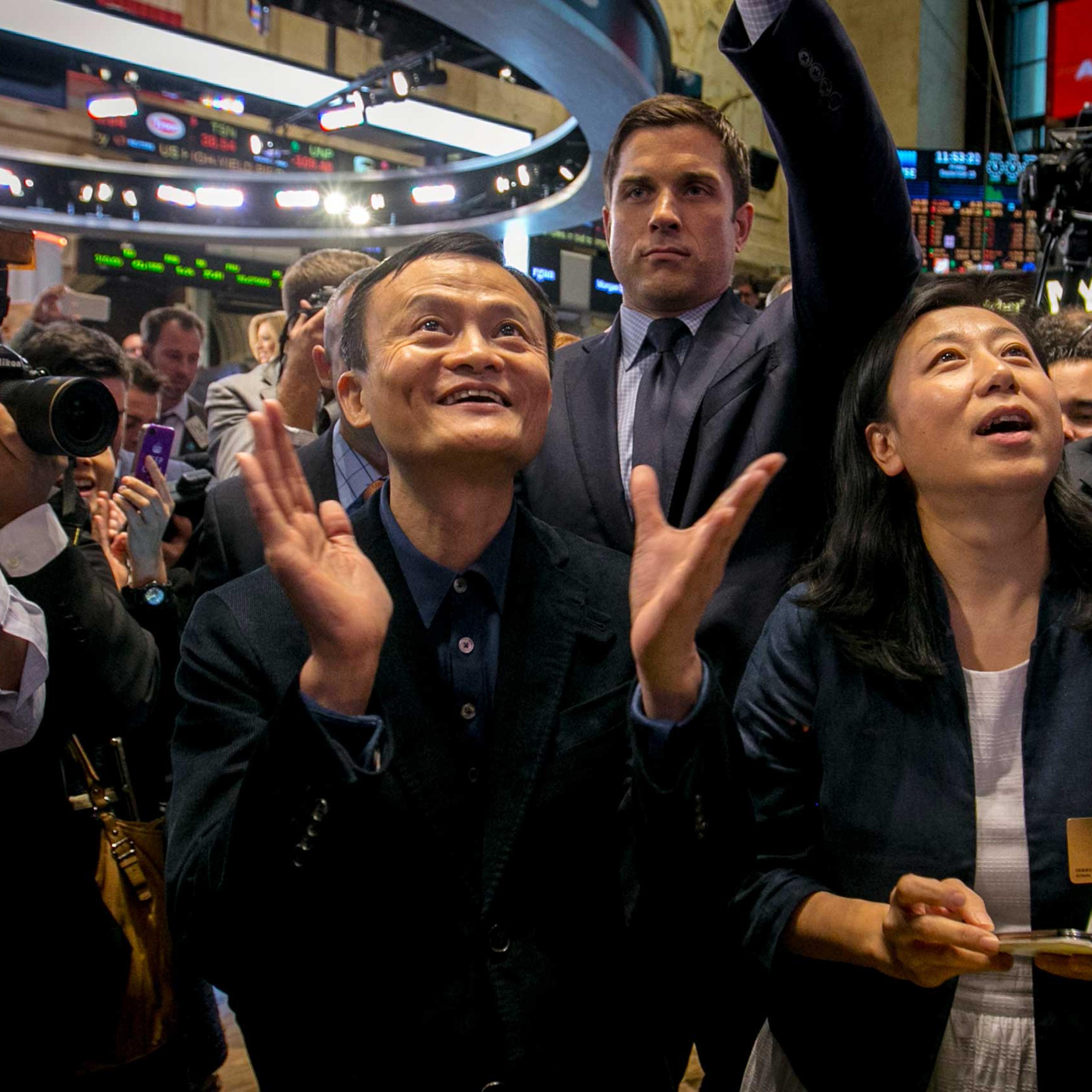 Alibaba founder Jack Ma and CFO Maggie Wu react as the company's IPO begins trading at the NYSE in New York