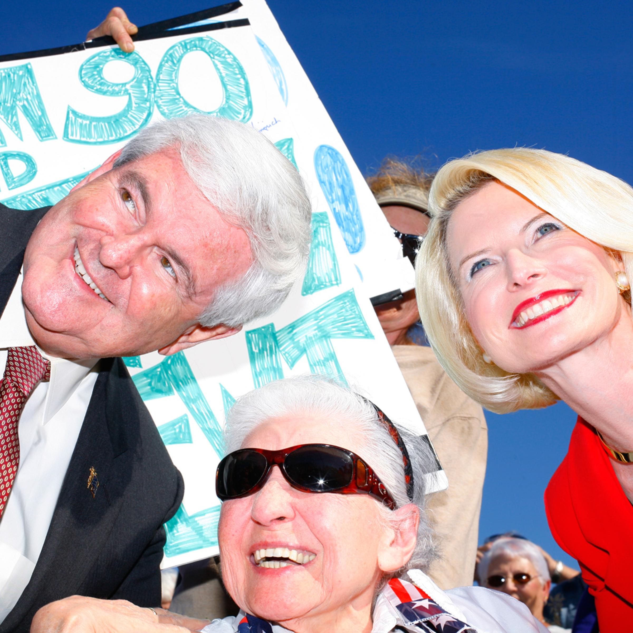 Newt and Callista Gingrich pose for photos during a rally at The Villages, Fla., January 29, 2012.