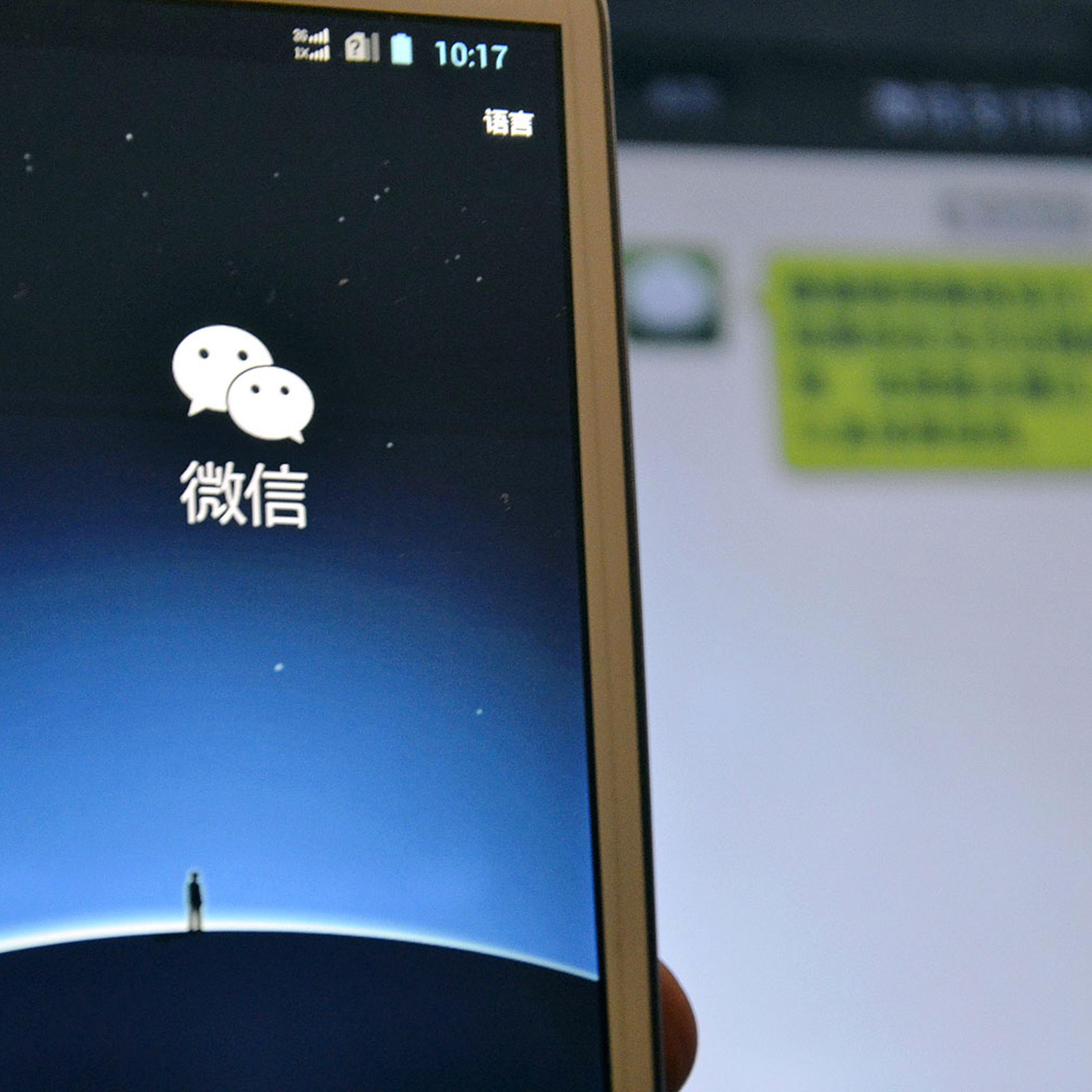 A mobile phone user uses the mobile messaging app WeChat of Tencent on a smartphone in Wenling, east Chinas Zhejiang province, 19 Oct. 2013
