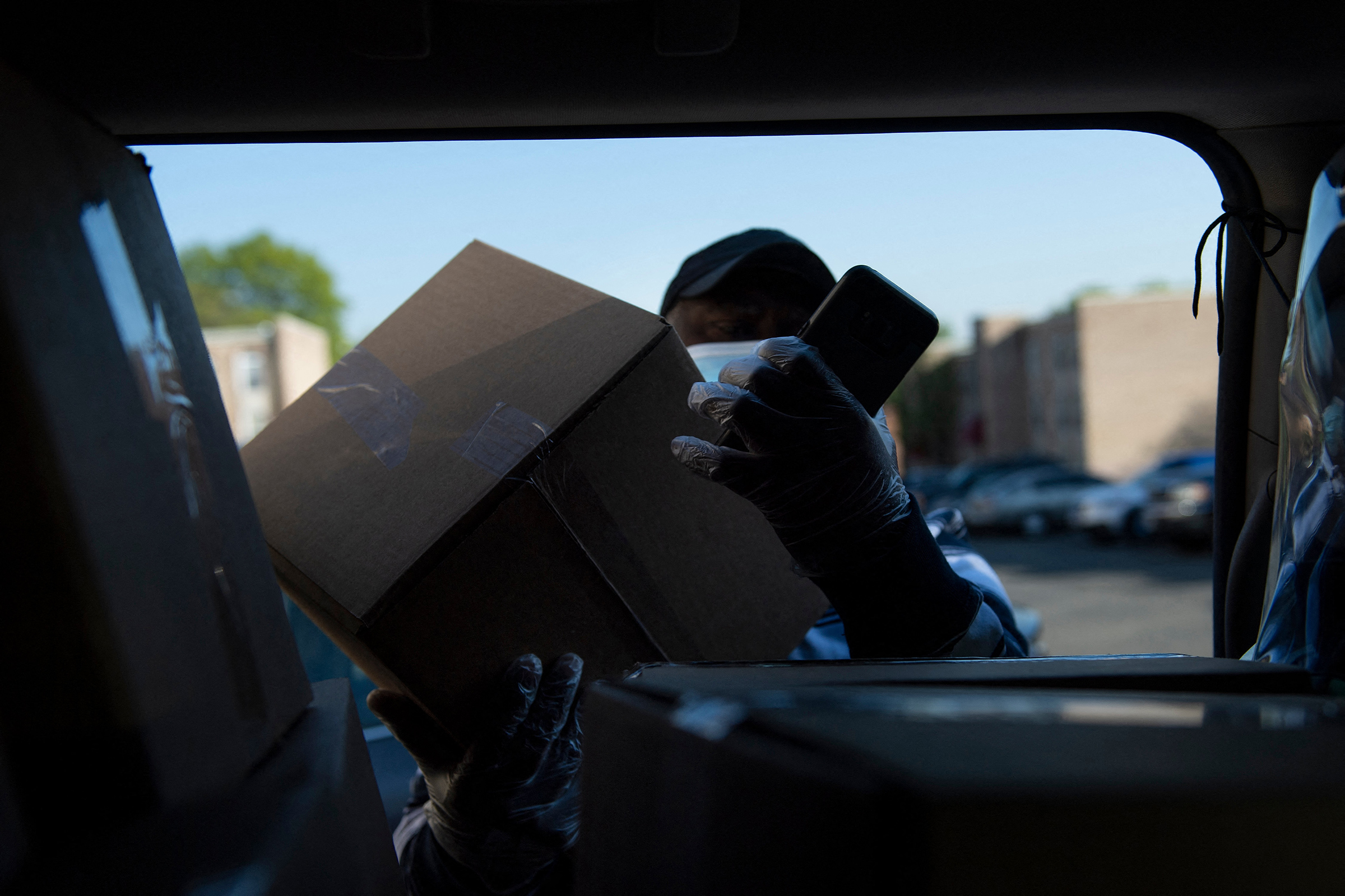 A longtime cab driver delivers food to seniors in Washington, D.C., on April 23, 2021.