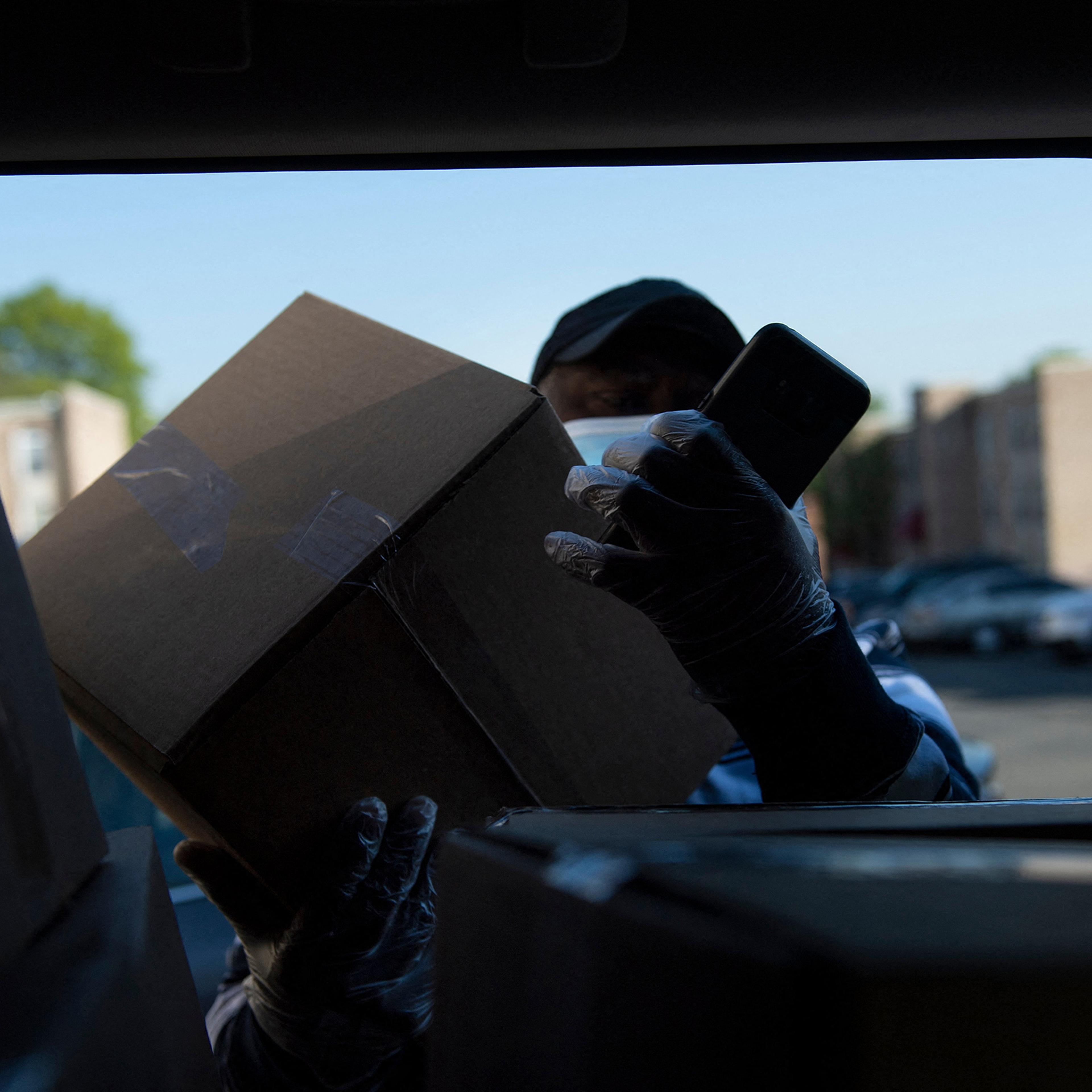 A longtime cab driver delivers food to seniors in Washington, D.C., on April 23, 2021.