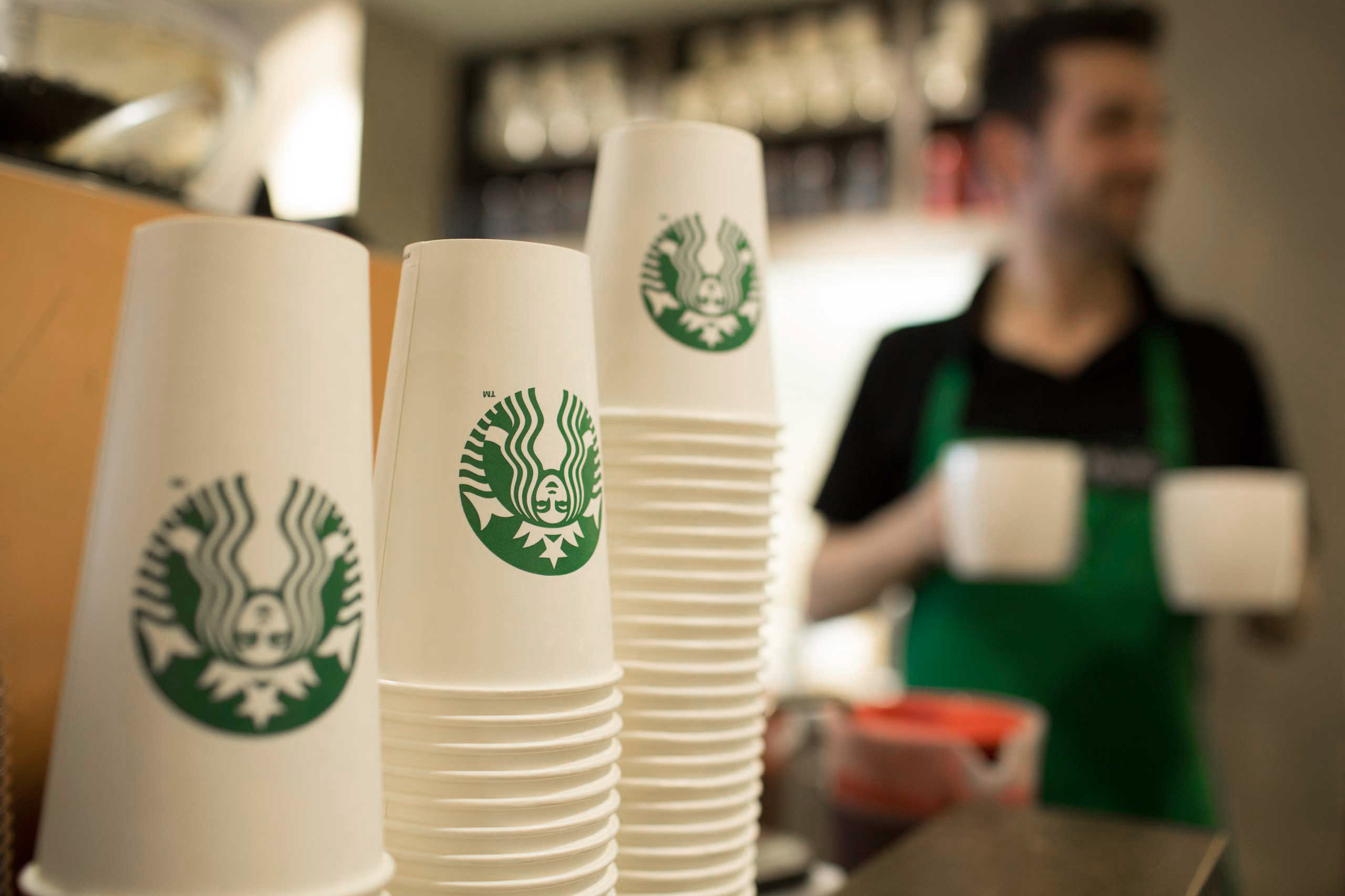 The Starbucks Corp. logo sits on cardboard coffee cups inside a Starbucks Corp. shop in London on June 9, 2014.