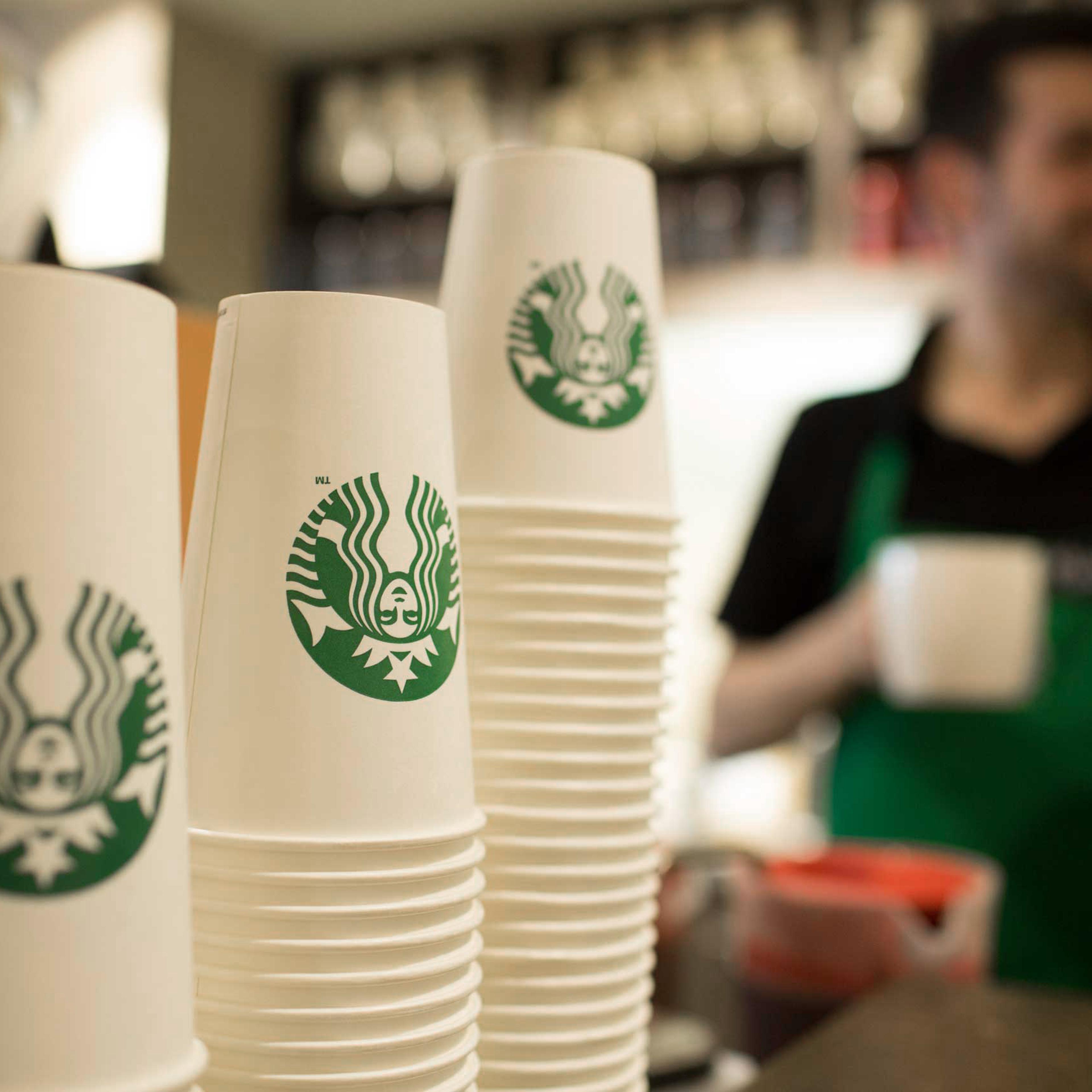 The Starbucks Corp. logo sits on cardboard coffee cups inside a Starbucks Corp. shop in London on June 9, 2014.