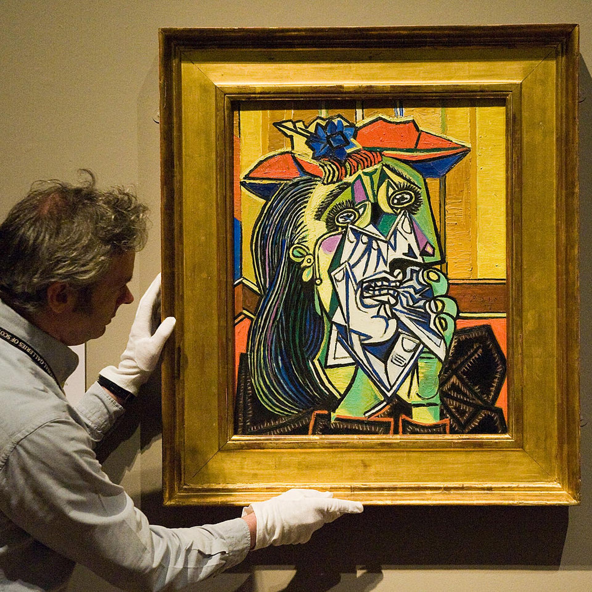 A National Gallery employee positions Picasso's 'The Weeping Woman' at the National Gallery 'Goya to Picasso' Exhibition on July 17, 2009 in Edinburgh, Scotland