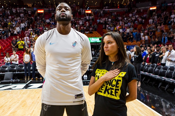 Dwyane Wade stands next to the sister of a Stoneman Douglas victim