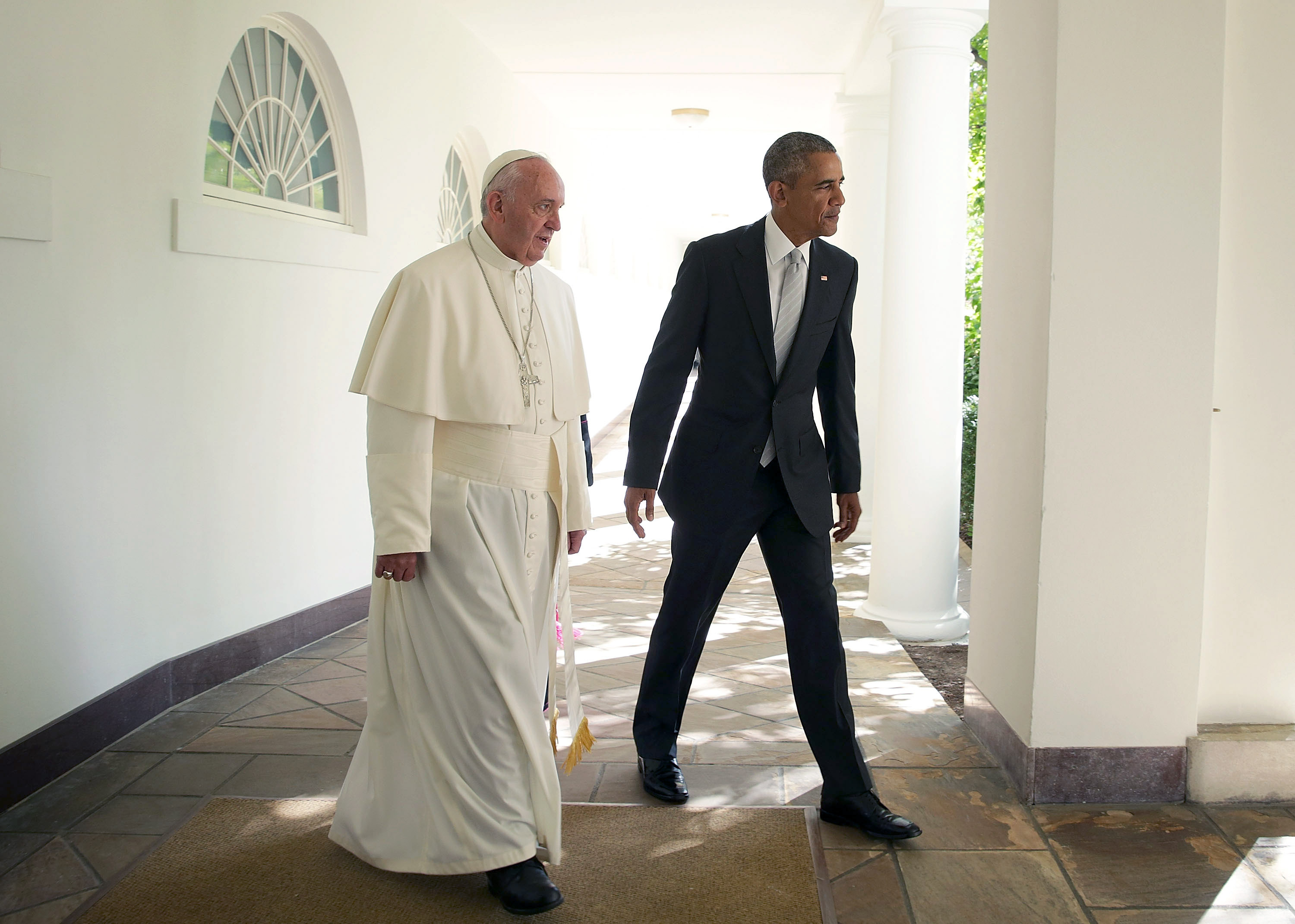 WASHINGTON, DC - SEPTEMBER 23:  U.S. President Barack Obama (R) and Pope Francis (L) walk through the colonnade prior to an Oval Office meeting at the White House on September 23, 2015 in Washington, DC. The Pope begins his first trip to the United State