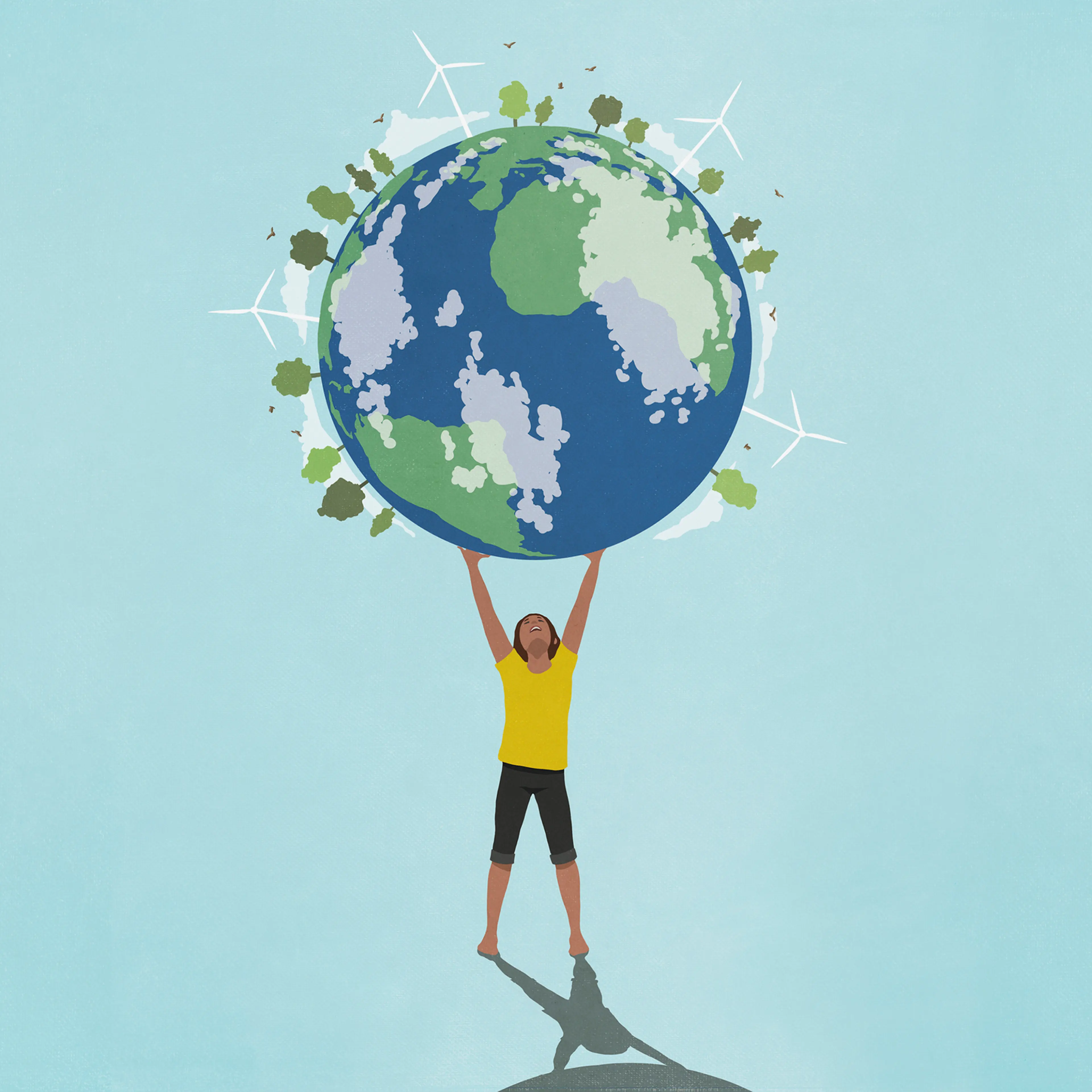 Determined, ambitious woman holding globe with wind turbines and green trees overhead