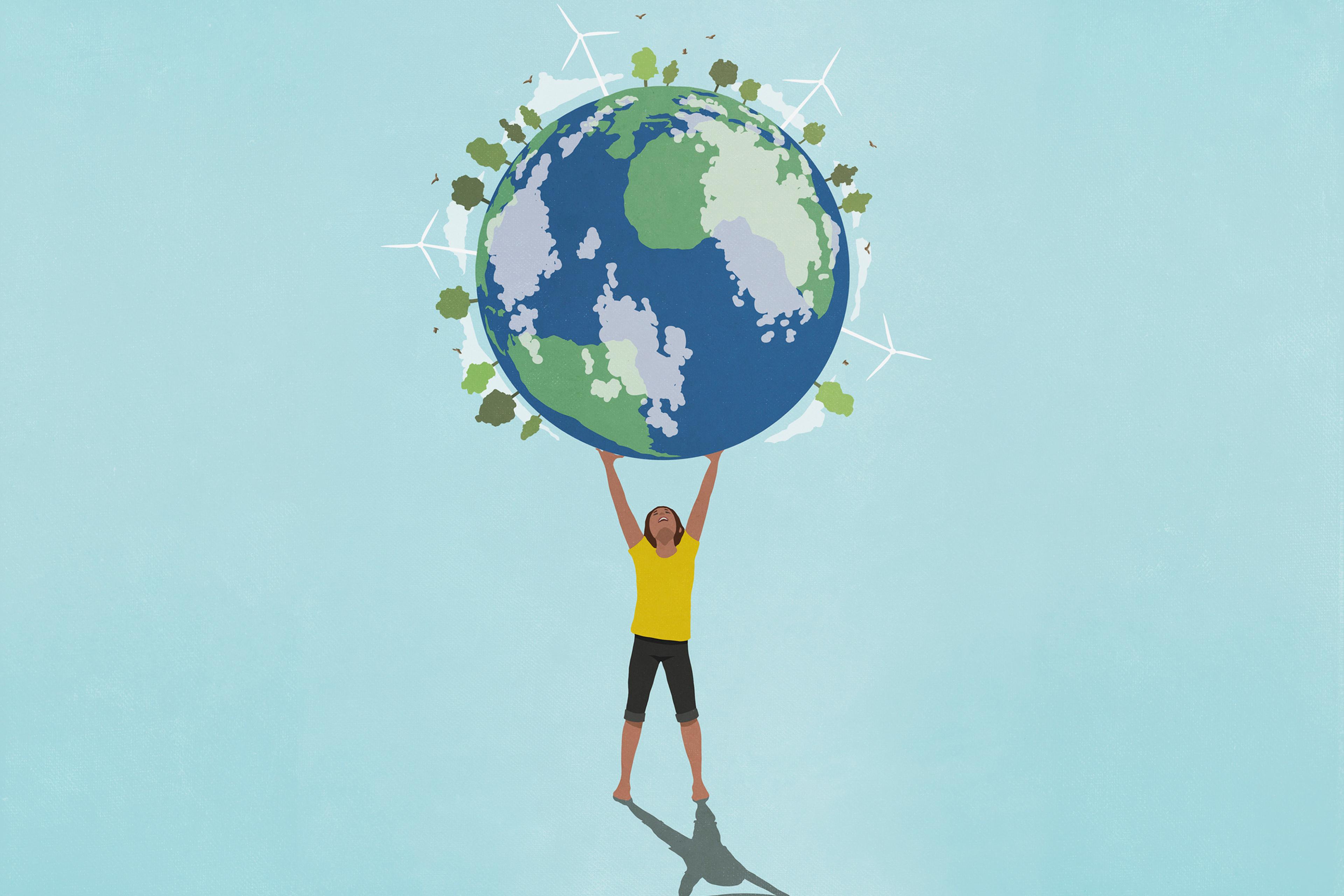 Determined, ambitious woman holding globe with wind turbines and green trees overhead