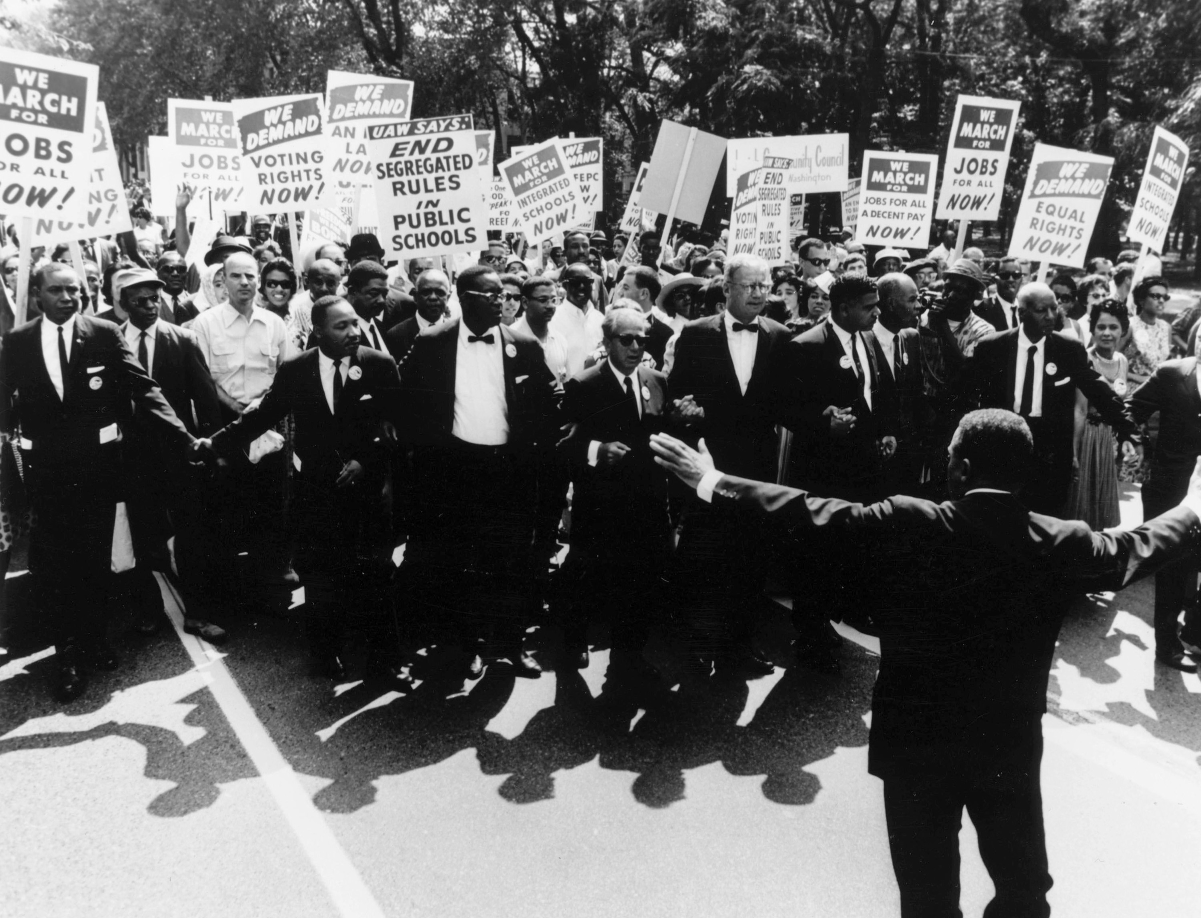 Martin Luther King, Jr. (fourth from left), A. Philip Randolph (second from right), and other civil rights and religious leaders walk with thousands of protesters for the March on Washington for Jobs and Freedom, in Washington, D.C., on Aug. 28, 1963.