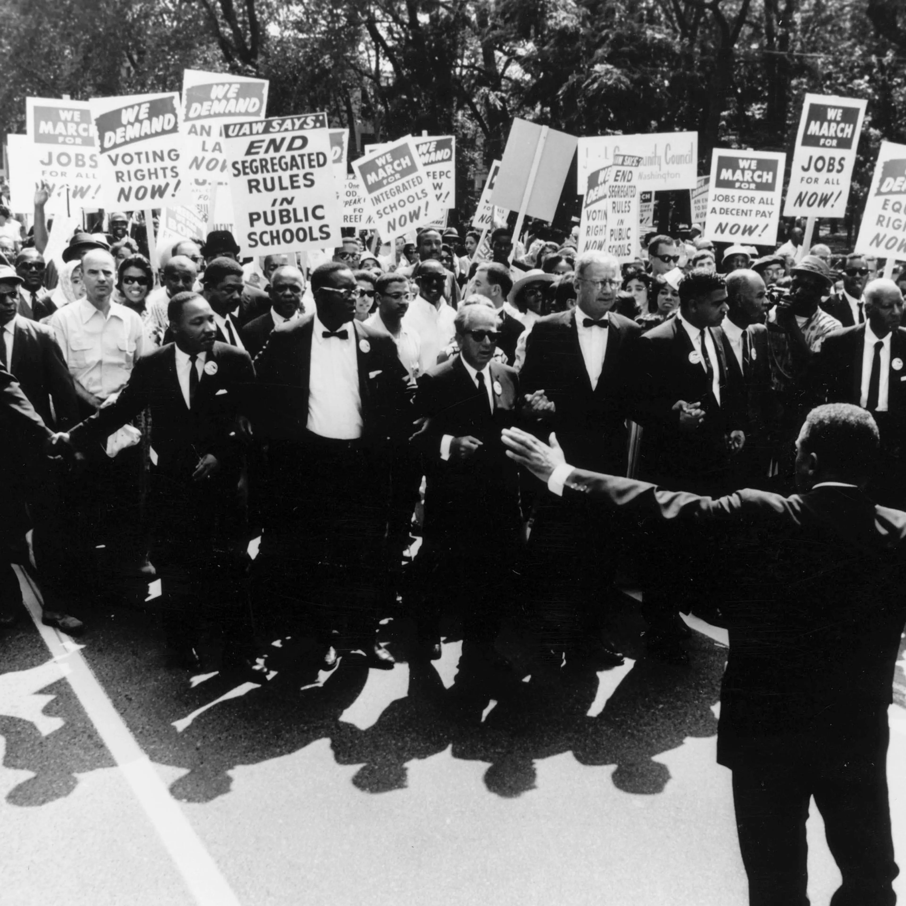 Martin Luther King, Jr. (fourth from left), A. Philip Randolph (second from right), and other civil rights and religious leaders walk with thousands of protesters for the March on Washington for Jobs and Freedom, in Washington, D.C., on Aug. 28, 1963.