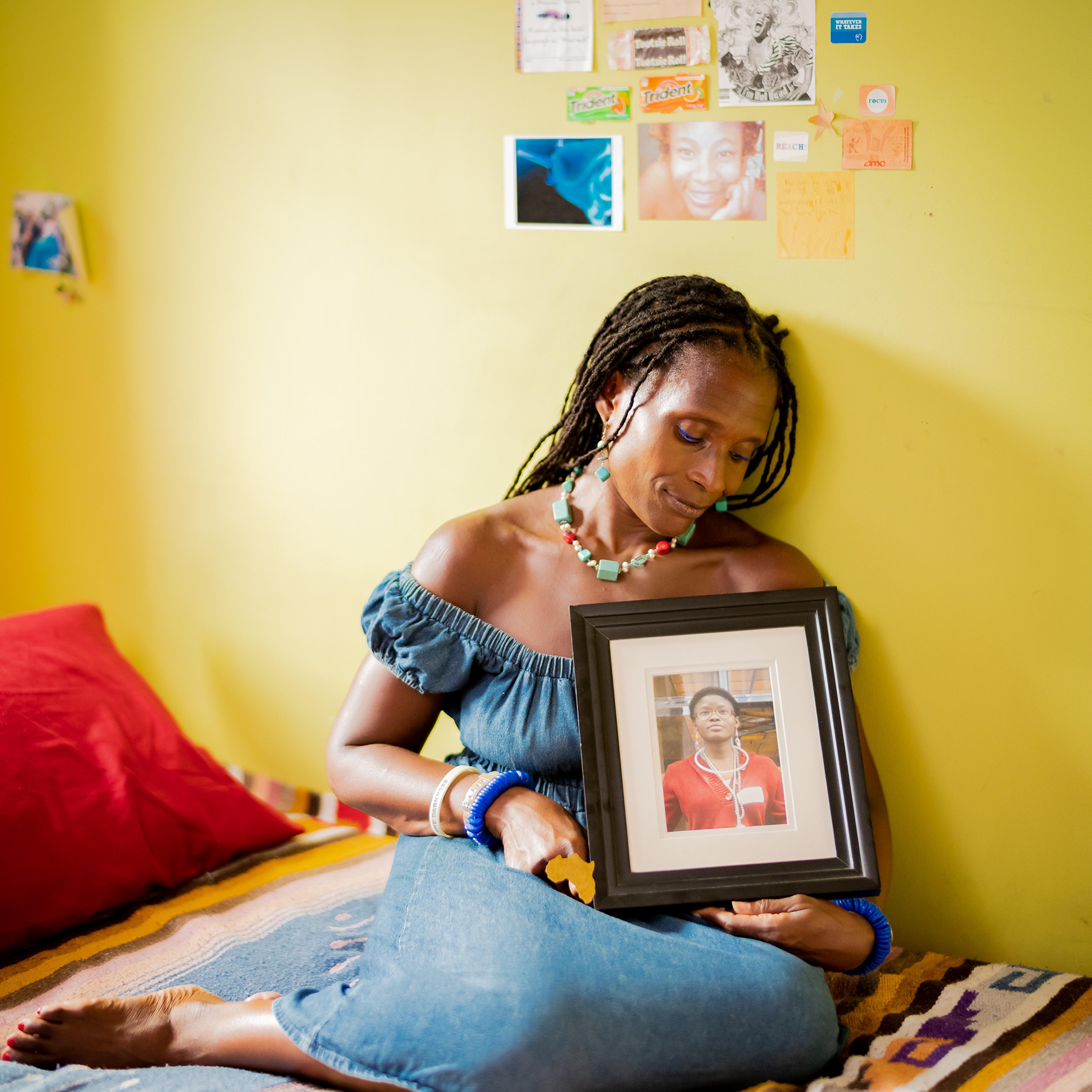 Dionne Monsanto holds a portrait of her daughter, Siwe, in the girl's bedroom in New York City, on Sept. 9, 2020. Siwe, 15, died by suicide in 2011.