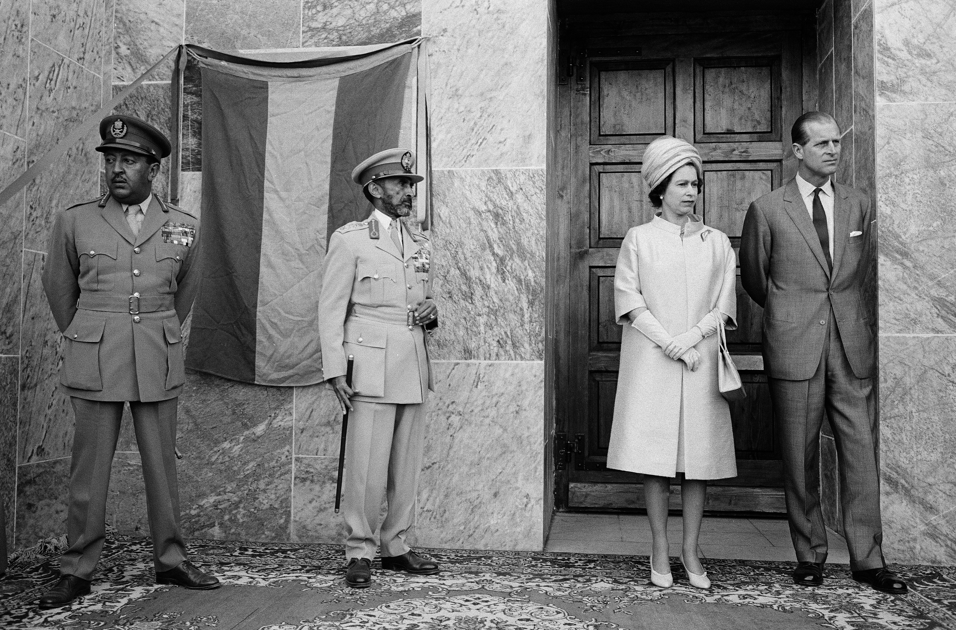 England’s Queen Elizabeth II and Duke of Edinburgh wait with their hosts, Emperor Haile Selassie of Ethiopia and his son, the Crown Prince, before they enter the New Cathedral of St. Mary of Zion. Axum, Ethiopia, 1965.