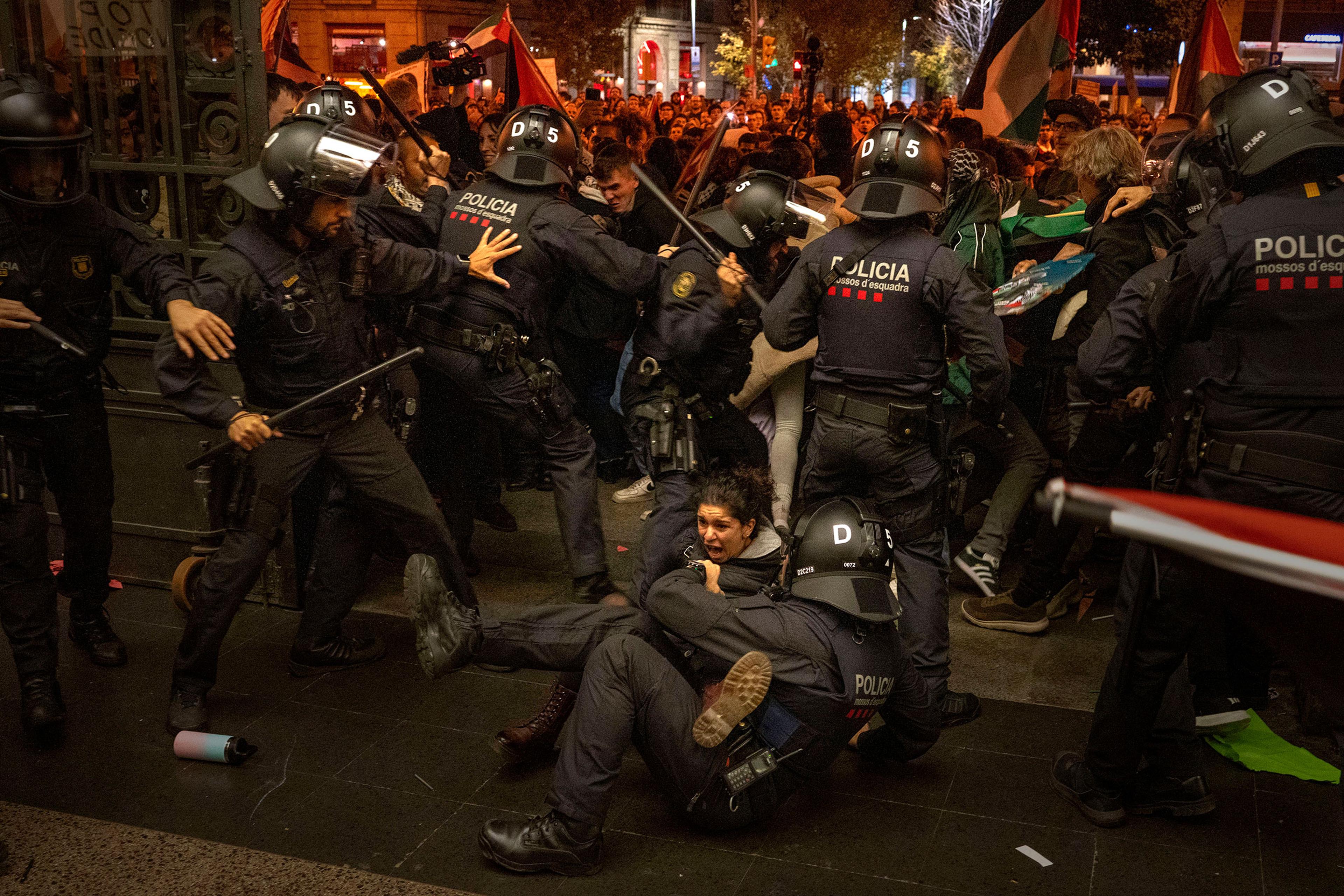 Police officers clash with pro-Palestinian demonstrators as they try to enter a train station in Barcelona, Spain, on Nov. 11. The protesters were part of a group of many thousands more who had earlier took part in an authorized march against Israel's re