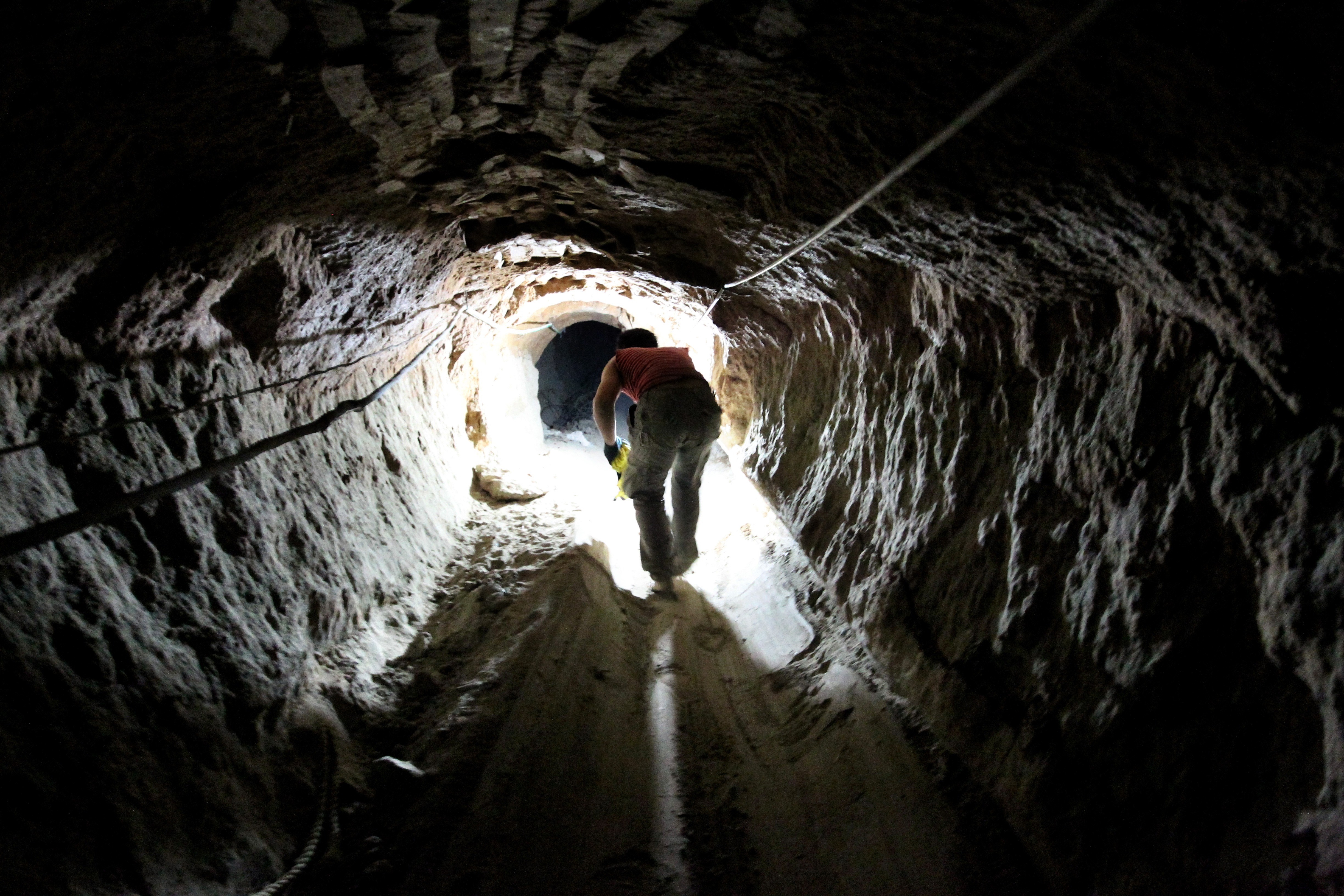 A Palestinian man works at a tunnel used