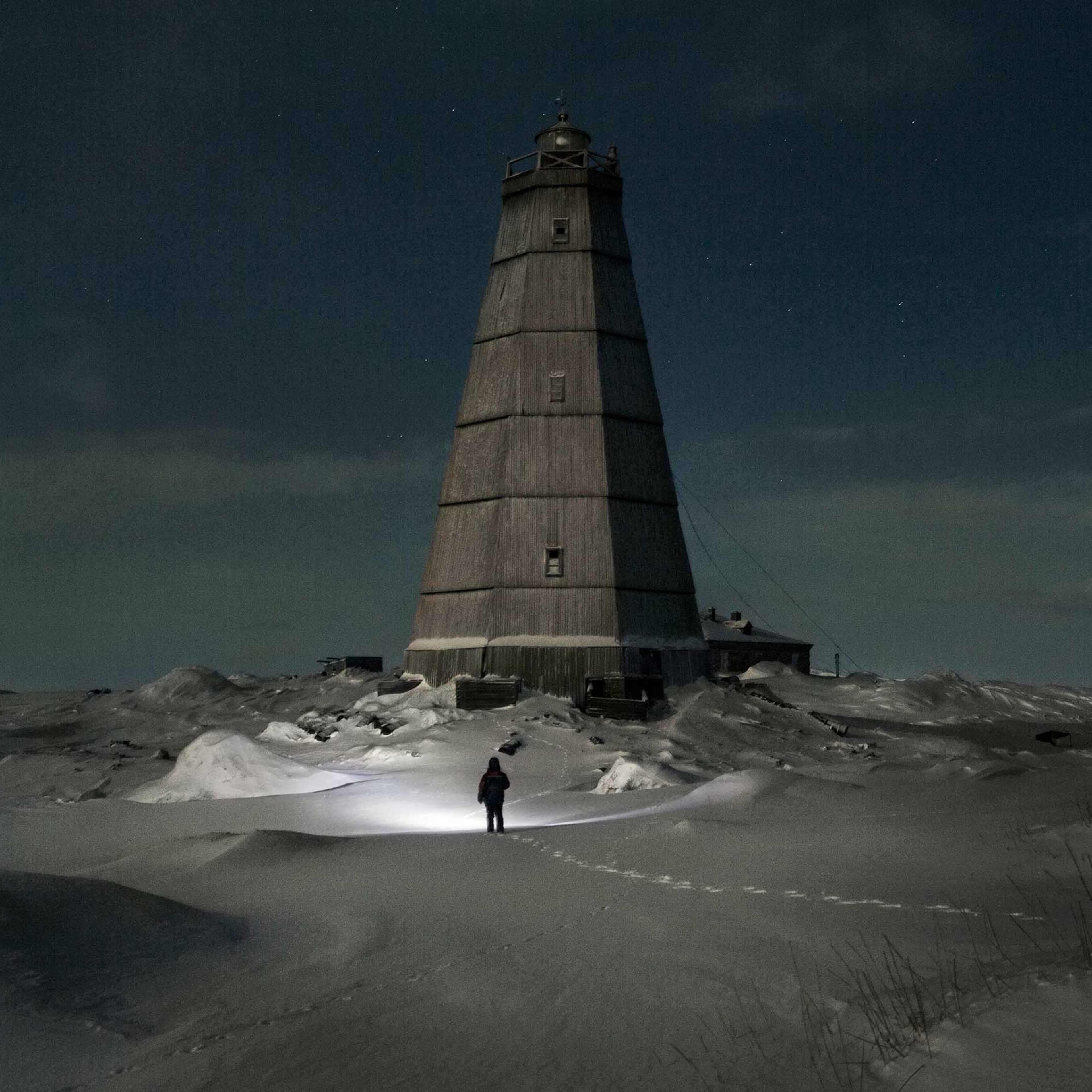 Slava walks to the old lighthouse near Hodovarikha meteorological station to take (dismantle) some fire wood from it’s walls. Full moon.